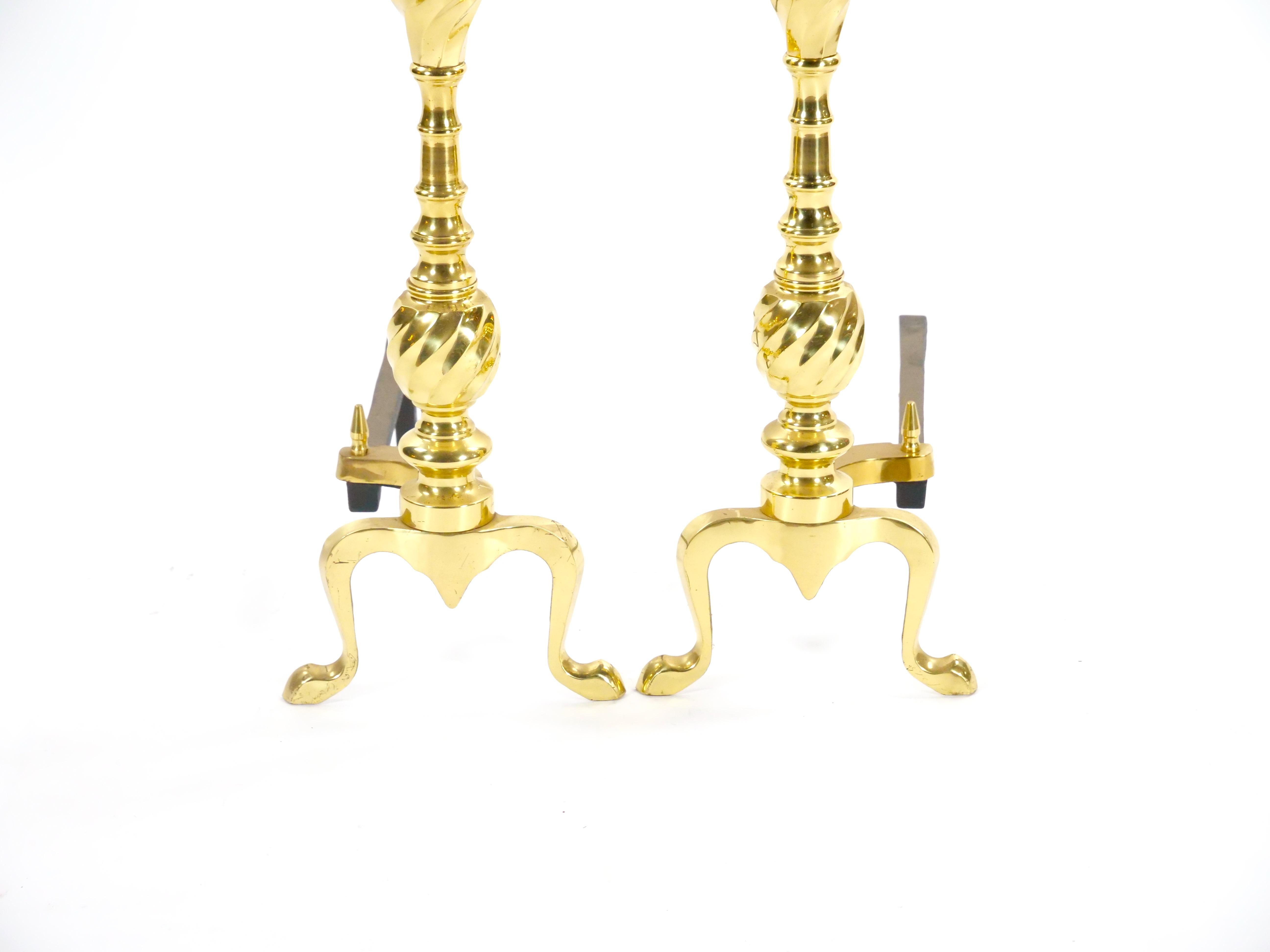 Add a touch of classic American elegance to your hearth with this striking pair of 20th-century Federal-style fireplace andirons. Each andiron features a beautifully detailed engraved finial, perched atop a round ball. The wrought iron poles are