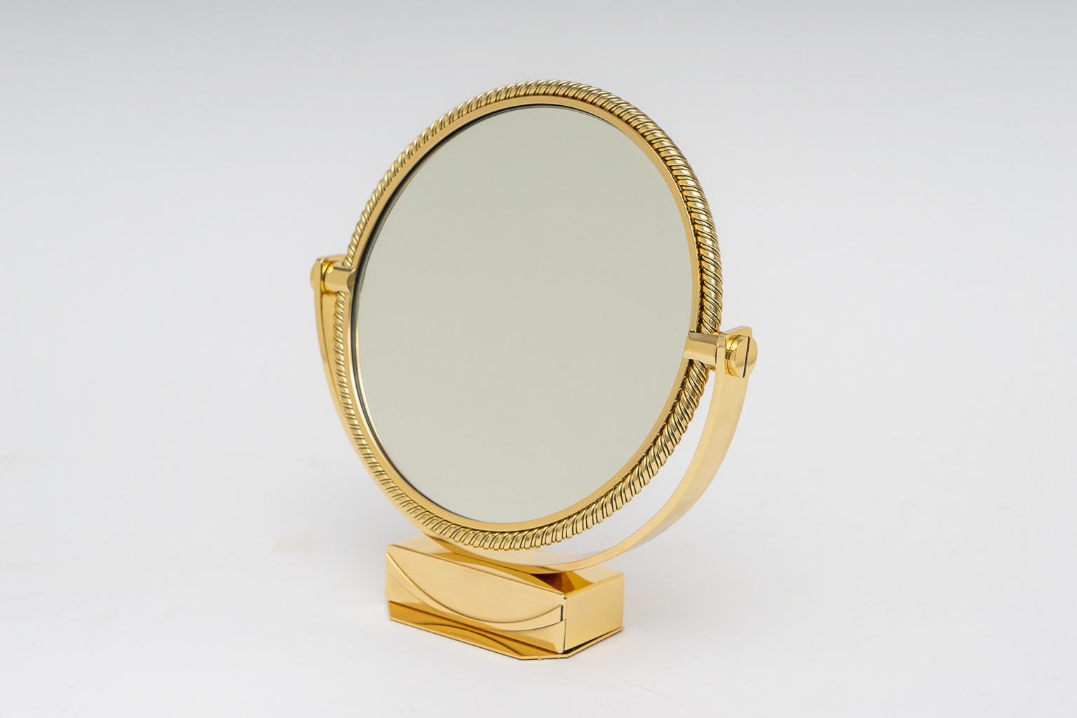 This stylish and chic dressing mirror dates to the 1970s-1980s and was created by the Swiss watch maker Piaget and it has been professionally polished and lacquered (no tarnishing) and a new piece of mirror.

Note: Dimension of mirror is 9.38