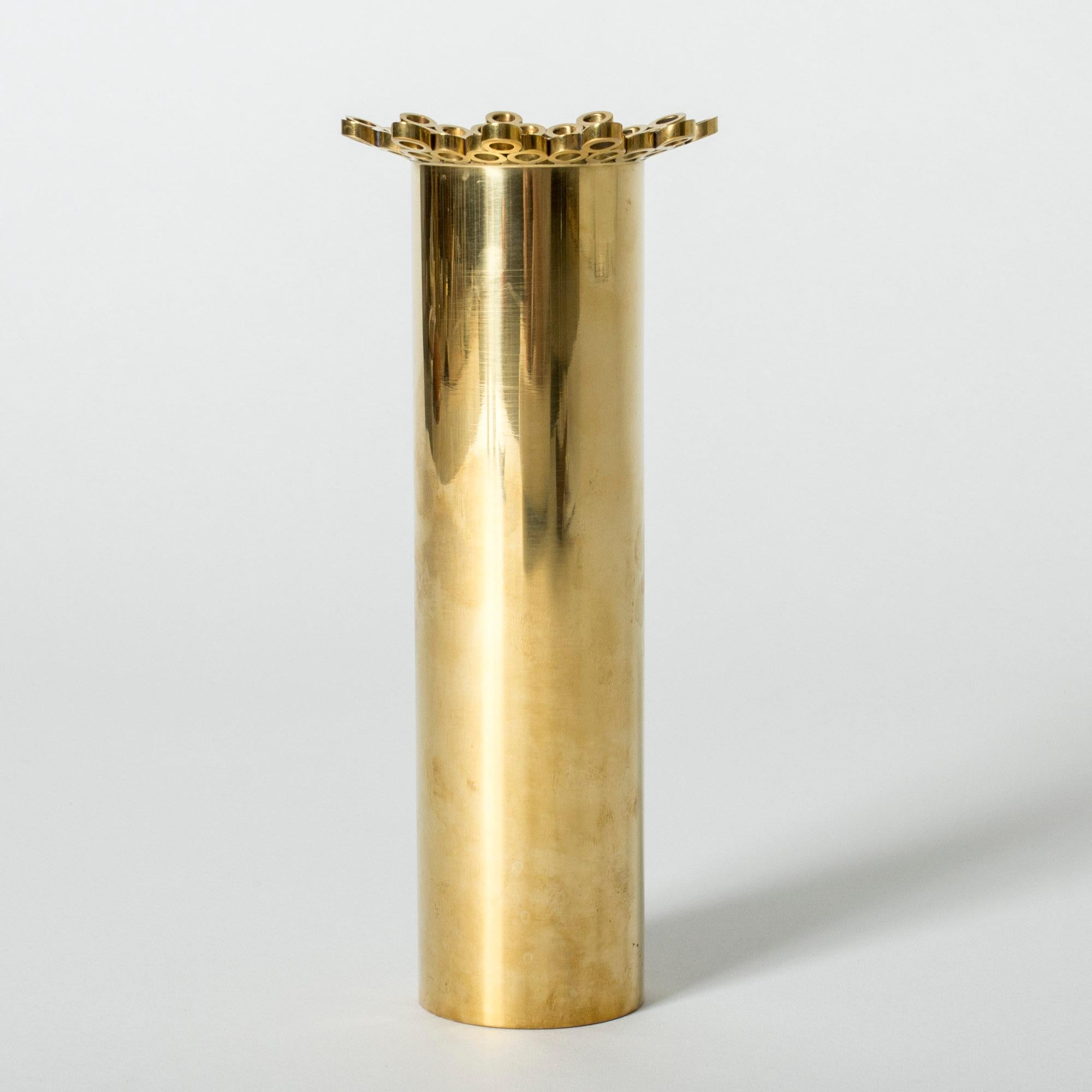 Tall brass vase by Pierre Forssell, with a cool frill of hoops around the rim.