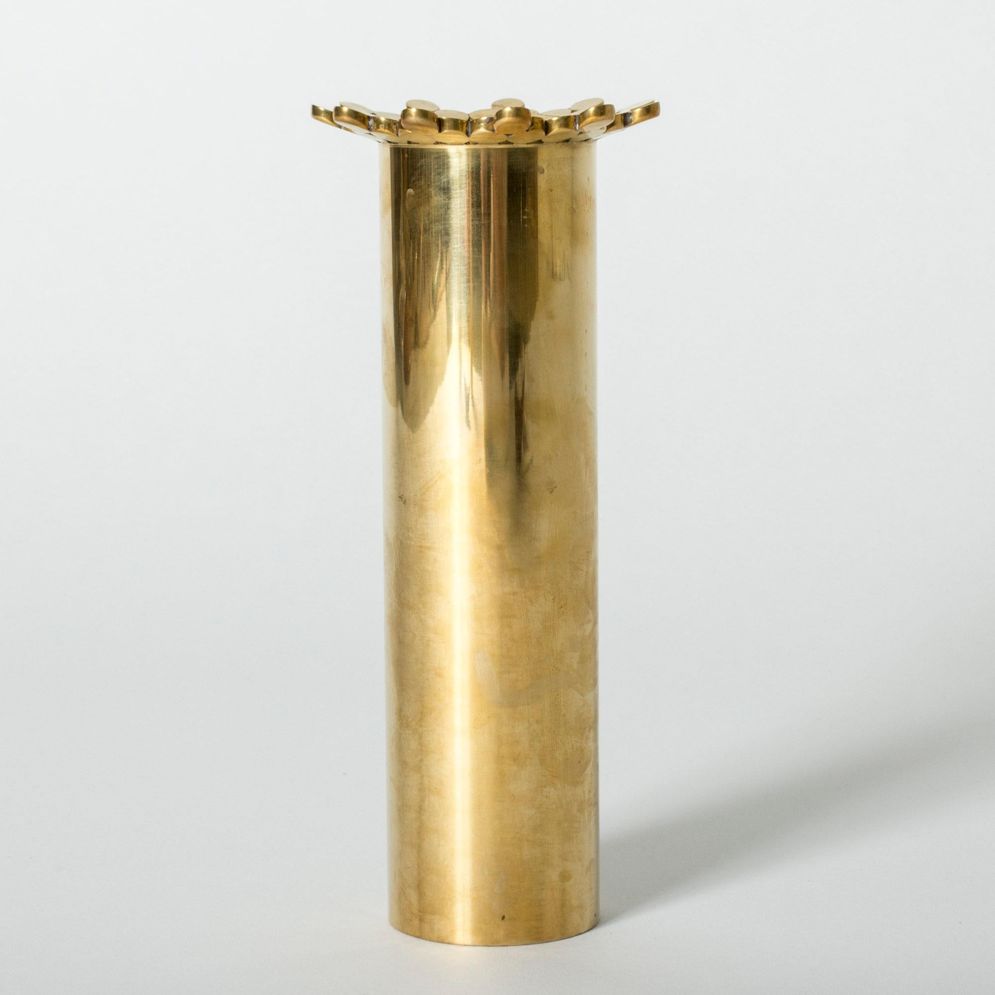 Tall brass vase by Pierre Forssell, with a cool frill of spheres around the rim.
