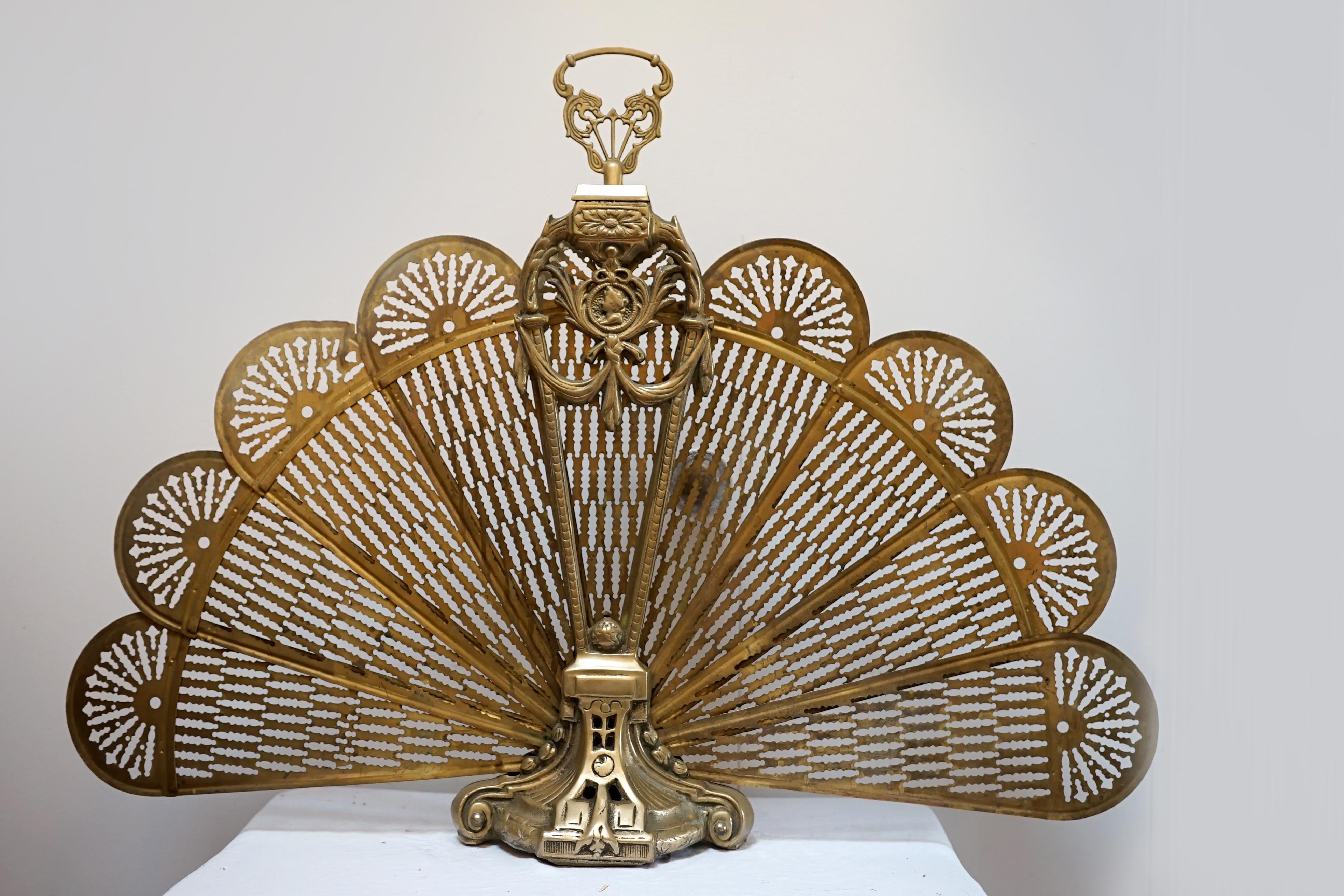 This exquisite Victorian-era peacock fireplace screen is crafted in solid brass, featuring a fan-style design that elegantly folds and unfolds like a peacock’s tail. The fan is in very good condition and it presents well folded or with the peacock