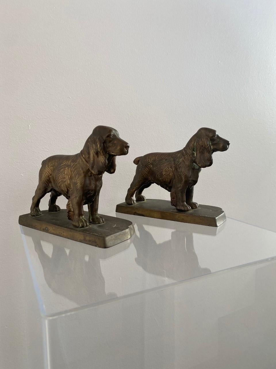1940s beautifully rendered sculpture bookends of cocker spaniels by Frankart. This pair is endearing and nostalgic. Crafted in brass, these are rendered to bring the sculptures to life. Natural light brings out glimmers of light against the brass