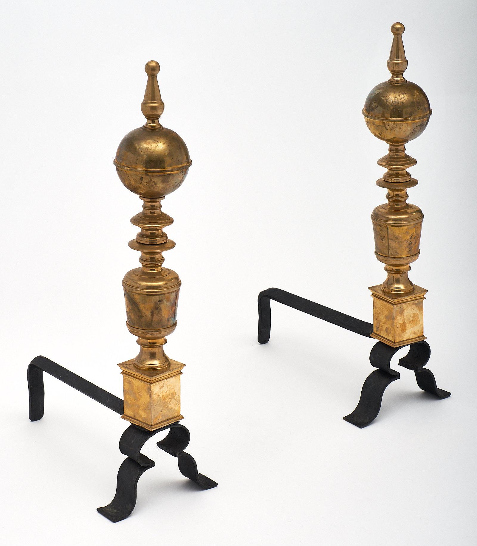 Vintage French brass andirons. We love the curved forms of this pair, with elegant finials. They are in excellent vintage condition and will elevate your hearth.