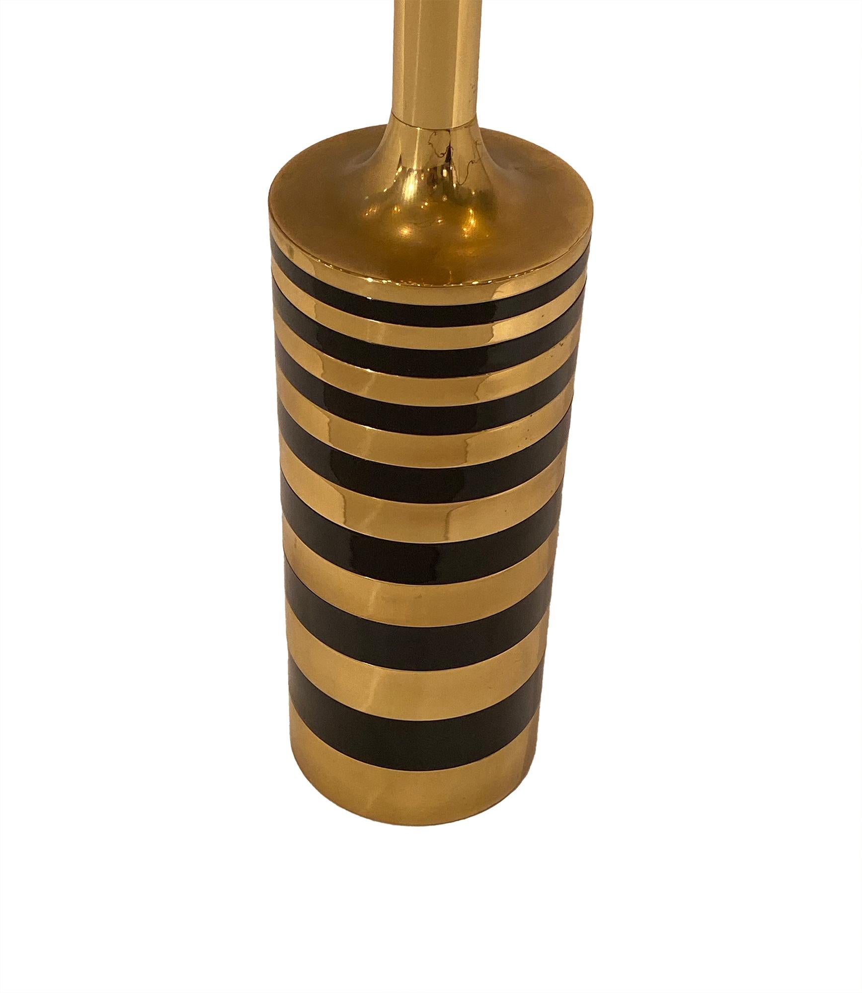 Brass vintage French table lamp in the modernist style. We love the gilt brass in contrast with the black lacquered steel and the impressive size. This piece has been newly wired to fit US standards.