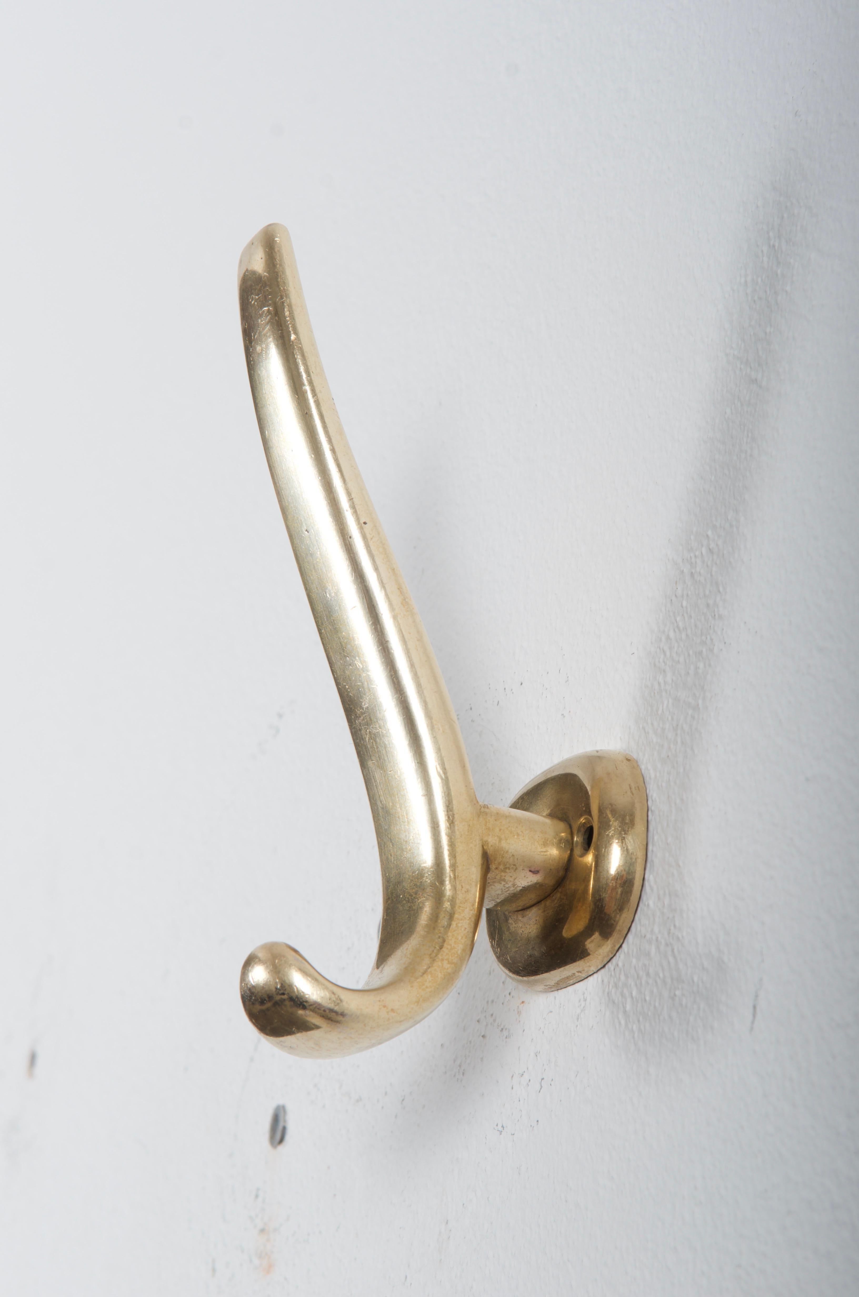Brass coat, hat hooks, elegant shape and perfect quality. Designed probably by Oswald Haerdtl and made in Austria in the early 1950s.
Original condition.
Up to five available, price per piece.
  
