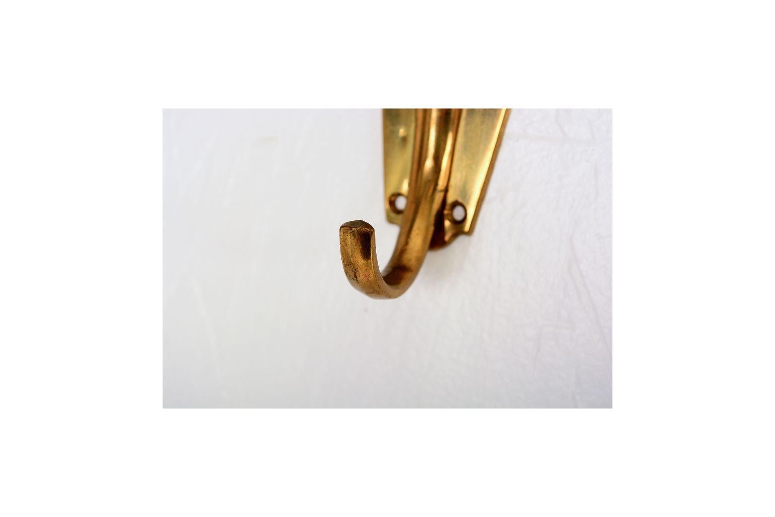 From AMBIANIC
Set of three wall coat hook racks in the style of Fontana Arte. 
Lucite Acrylic on brass. Italy, 1950s. 
Dimensions: H 5.5 in. x W 5.4 in. x D 2.7 in. 
Original vintage preowned condition, refer to images. 
