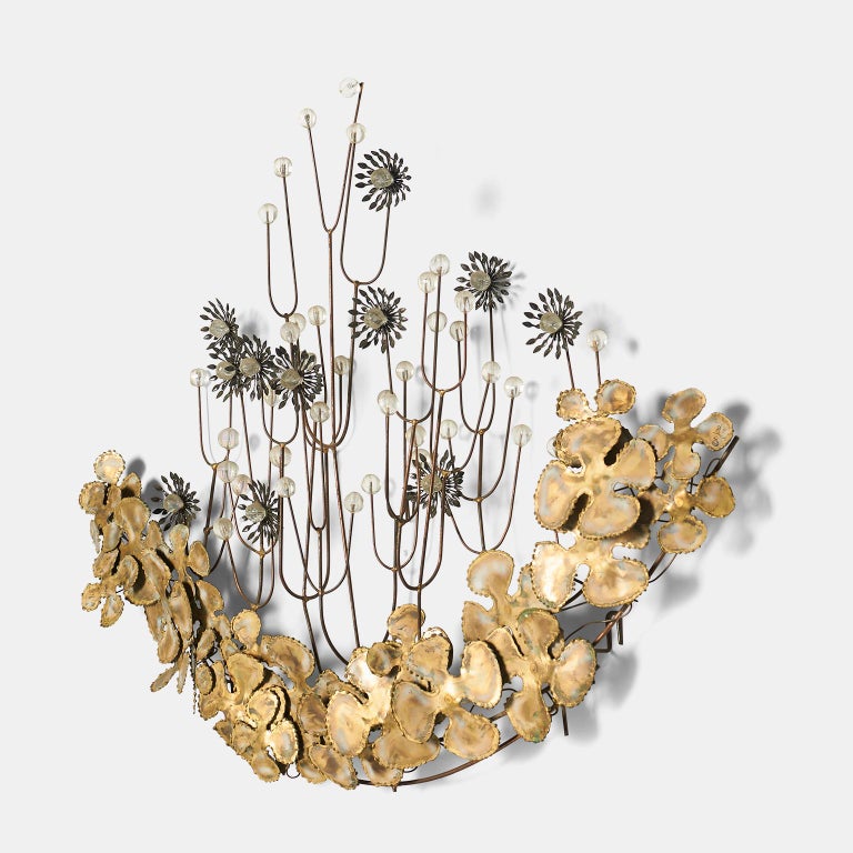 A brutalist wall hanging by Curtis Jere. Leaves and flowers are sculpted from brass and the flowers are accentuated with clear glass faceted beads.