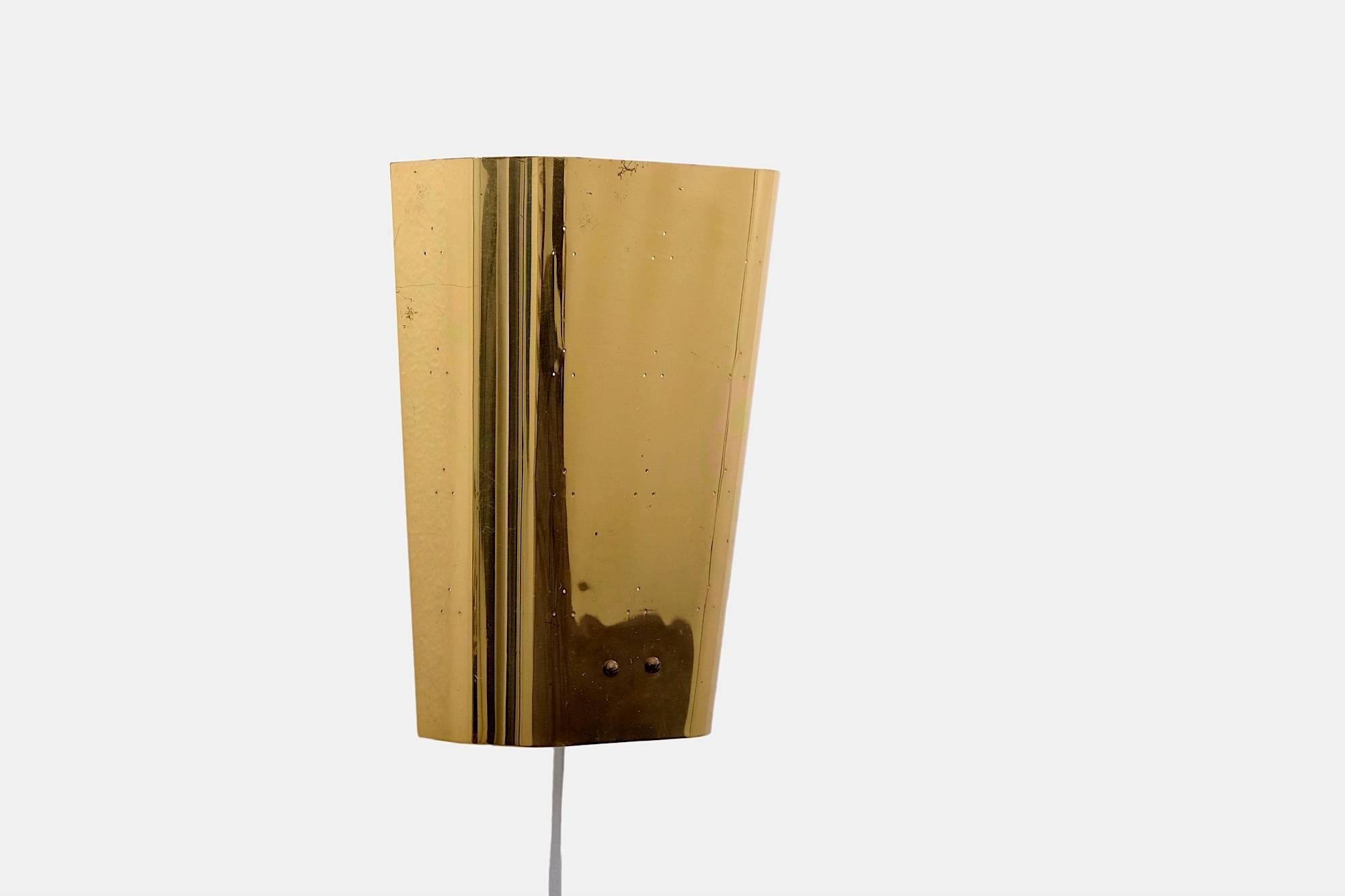 Brass wall lamp model EY 55, designed and manufactured in Finland by Itsu. Two E27 sockets behind a perforated brass plate.

This lamp is in the style of Finnish designers like Lisa Johansson-Pape and Paavo Tynell.