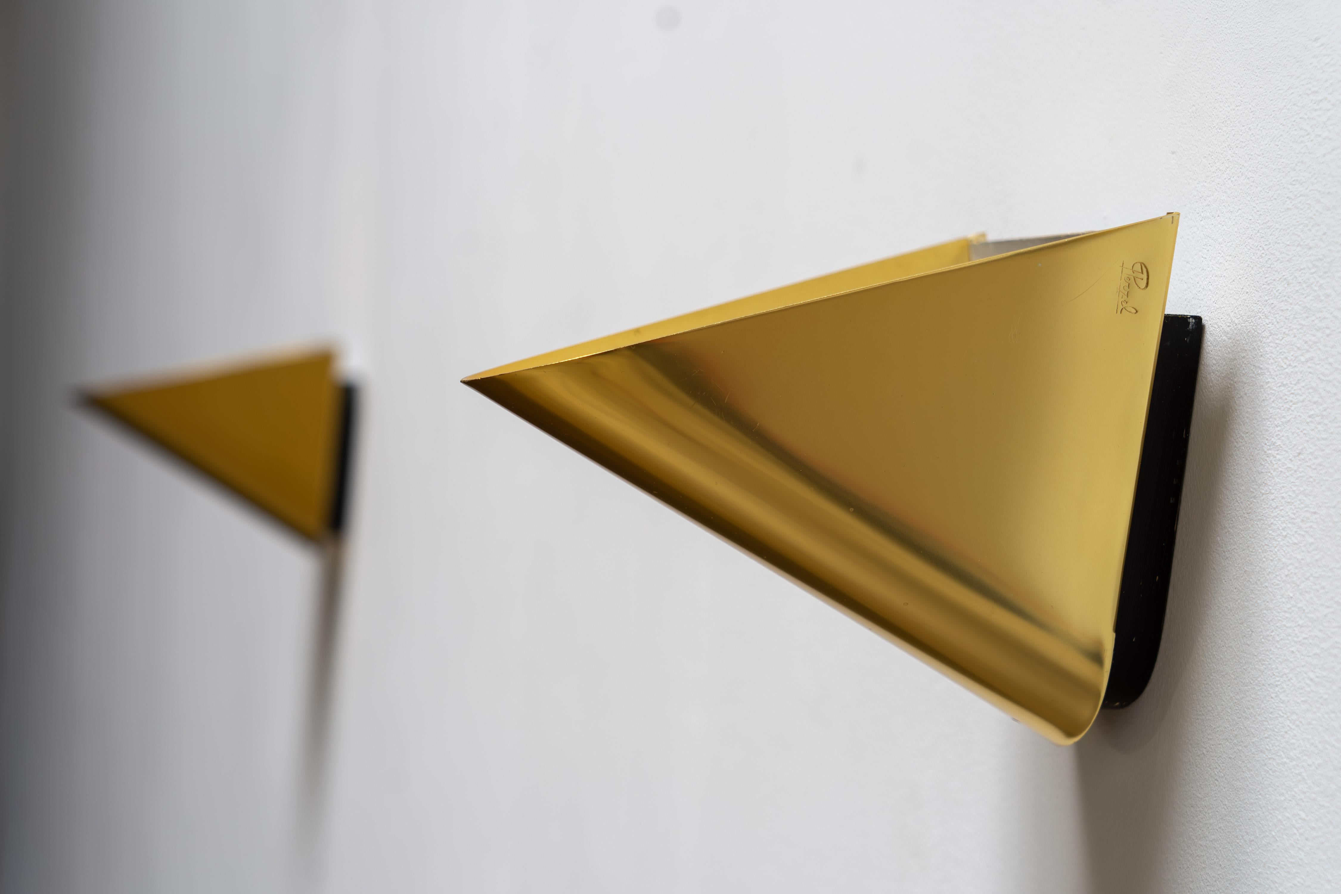 Elegant and rare pair of brass wall sconces by Jean Perzel. Designed and crafted in France, these timeless pieces embody the refined aesthetic of Atelier Perzel. A true collector’s item and a striking decorative addition to any interior.