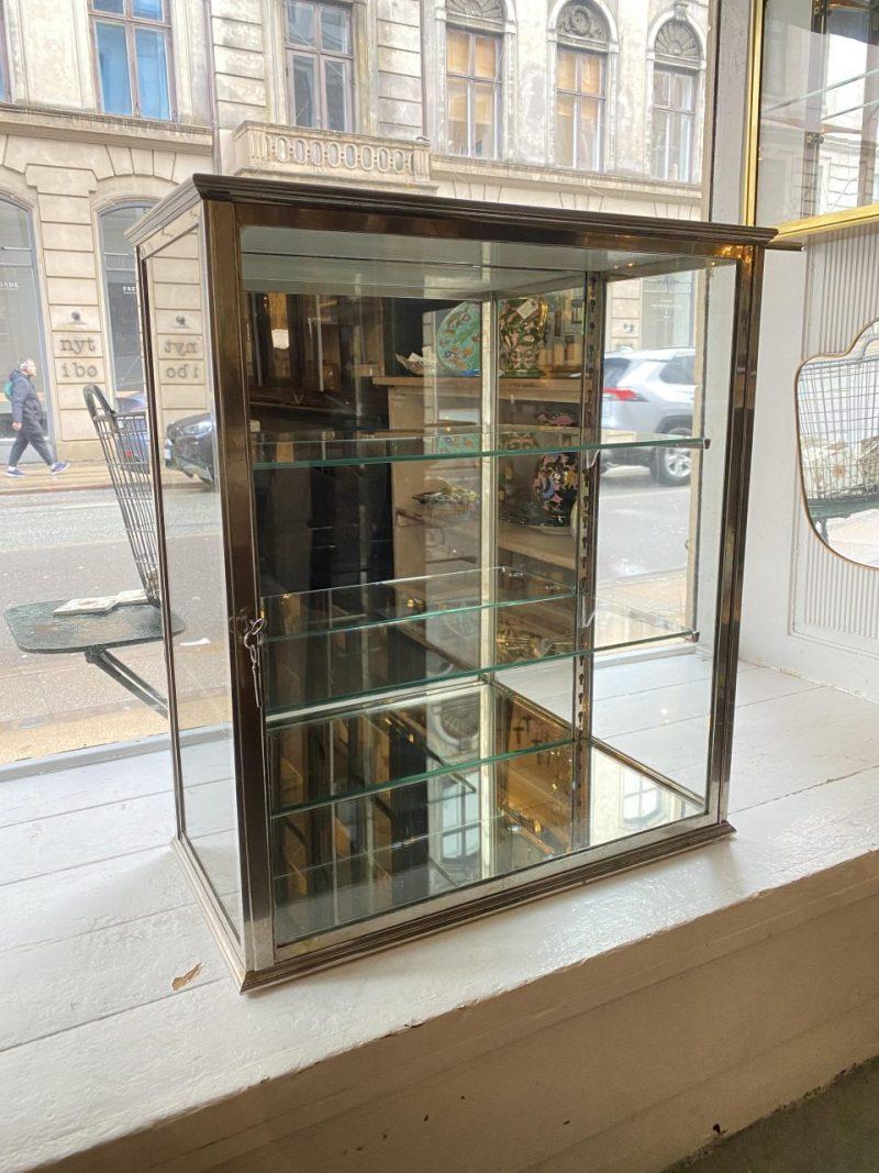 Handsome French wall vitrine, made of quality chrome and original glass (including two height adjustable matching shelves). It comes with its two original keys. It can also be placed on a table or counter.

This lovely display cabinet was part of a
