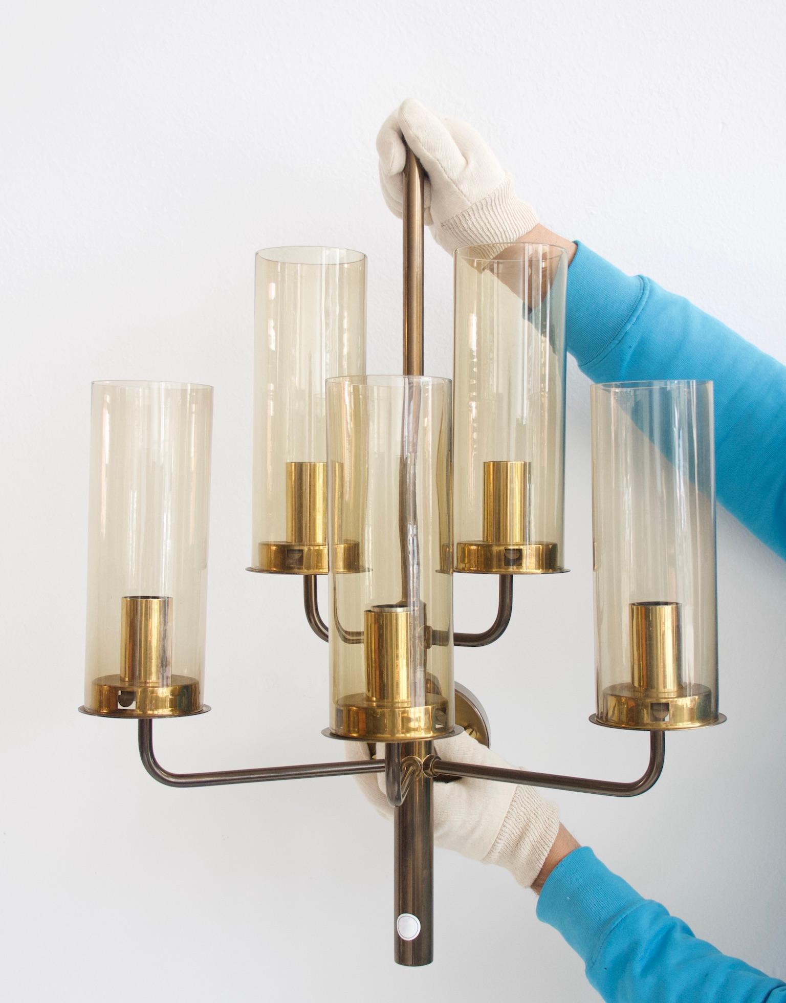 Elegant brass wall lamp with five arms and lights, amber glass shades, designed by Hans-Agne Jakobsson. Made in Sweden by AB Markaryd.