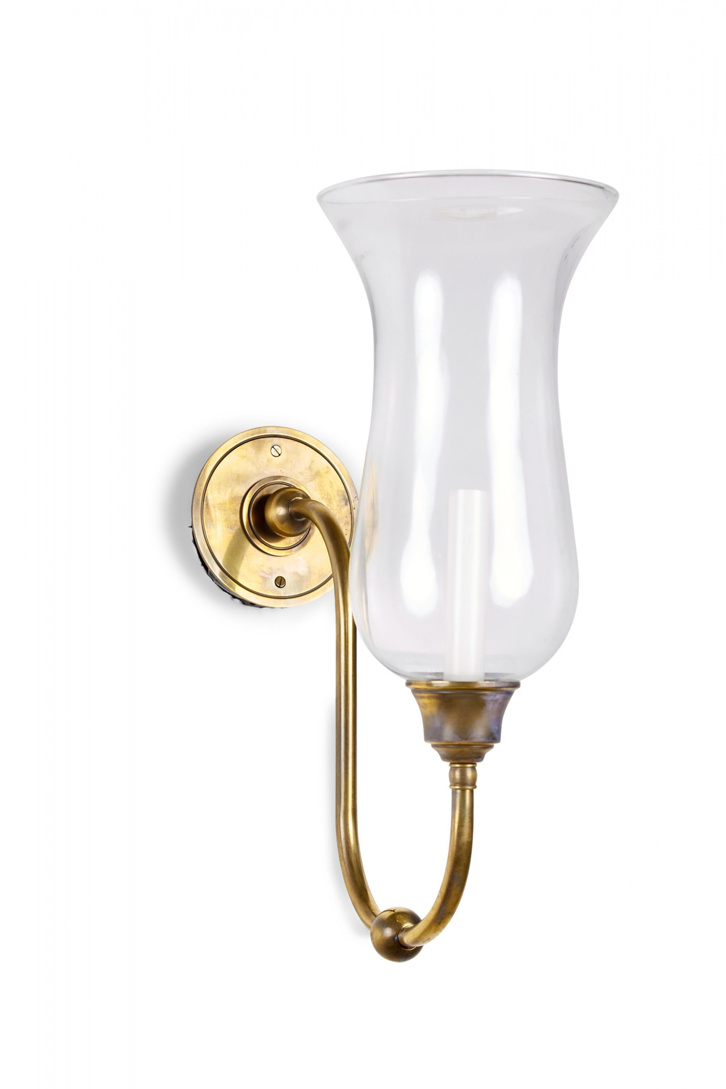 Contemporary antiqued brass wall sconce with hurricane globe shade.

Condition: Good; Wear consistent with age and use