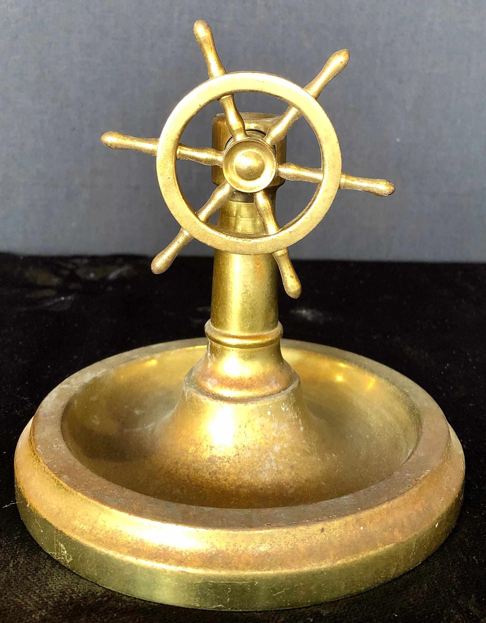 Brass wheel cigar cutter. Three available at the time of this listing. Part of an enormous collection of cigar cutter and memorabilia.
A memento from a voyage and sea, the vintage brass nautical cutter is in the form of ship's wheel, spinning the