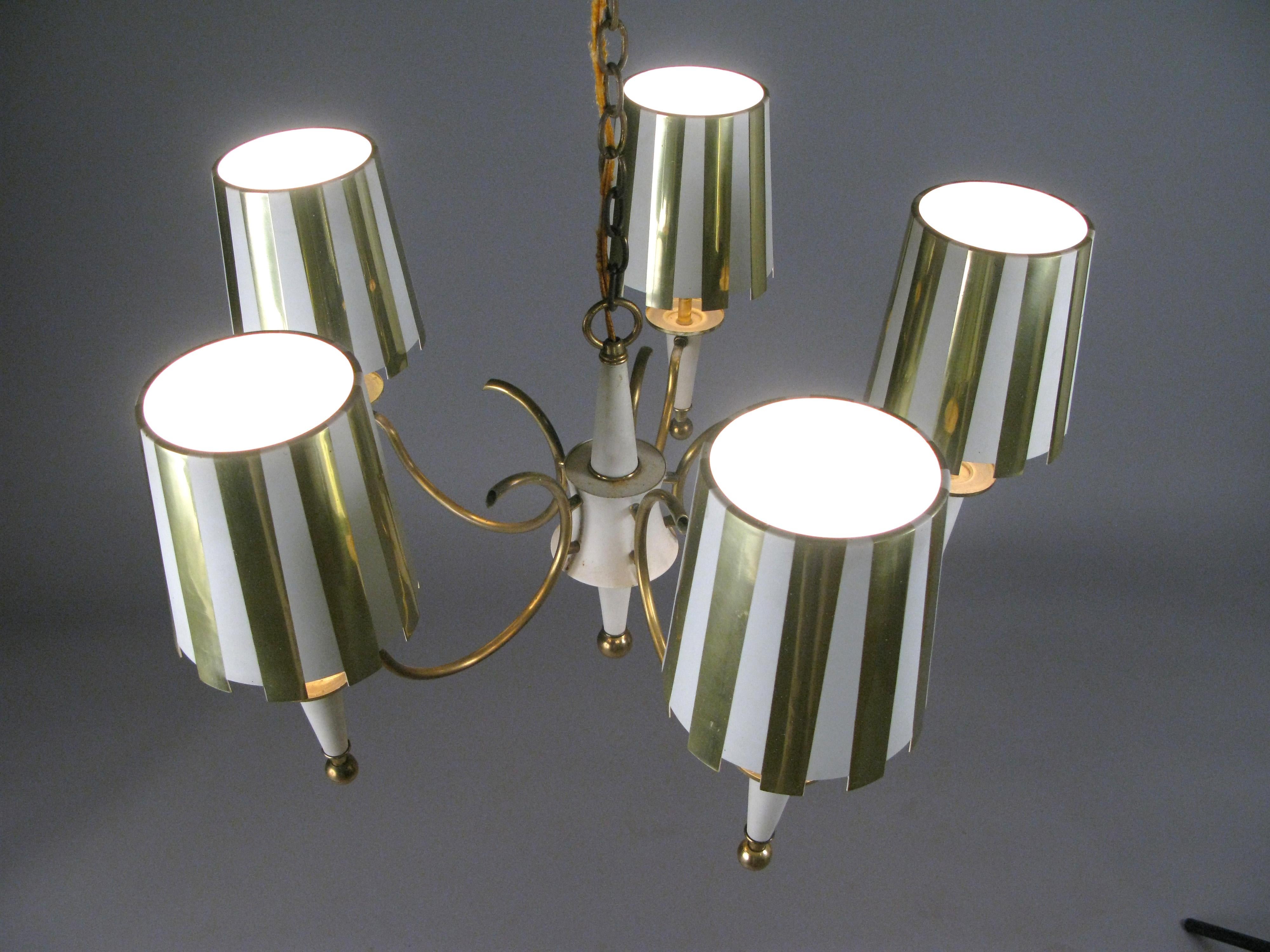 A very charming vintage 1960s five-light chandelier, with a brass frame, and five shades in polished brass and white stripes. Each shade has a mesh diffuser underneath with original wiring.