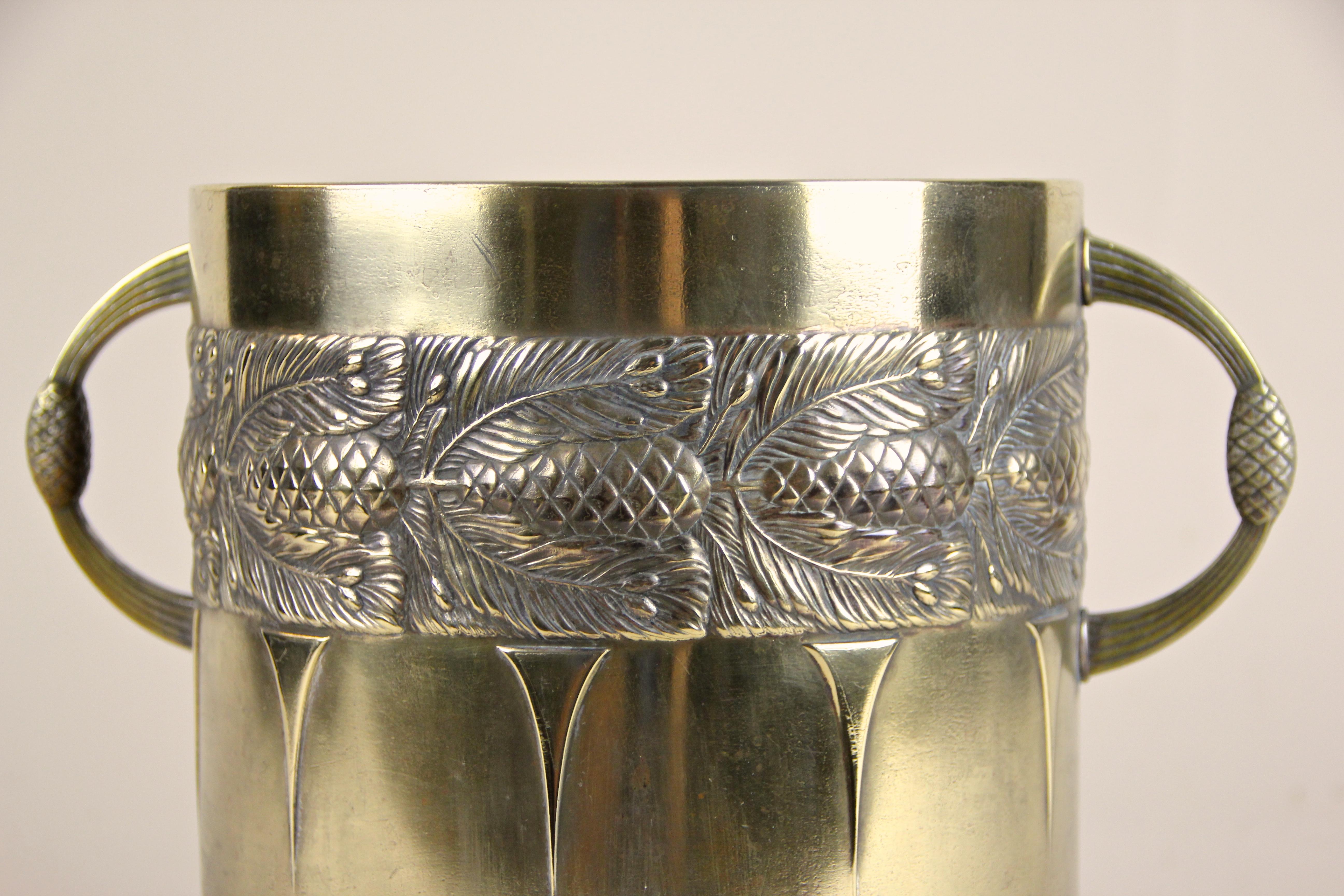 Brass wine cooler or cachepot artfully made by the famous company of WMF from the Art Nouveauperiod in Germany, circa 1915. The great shaped brass bottle holder shows a beautiful embossed design with pinecones and lovely made handles. It can be used
