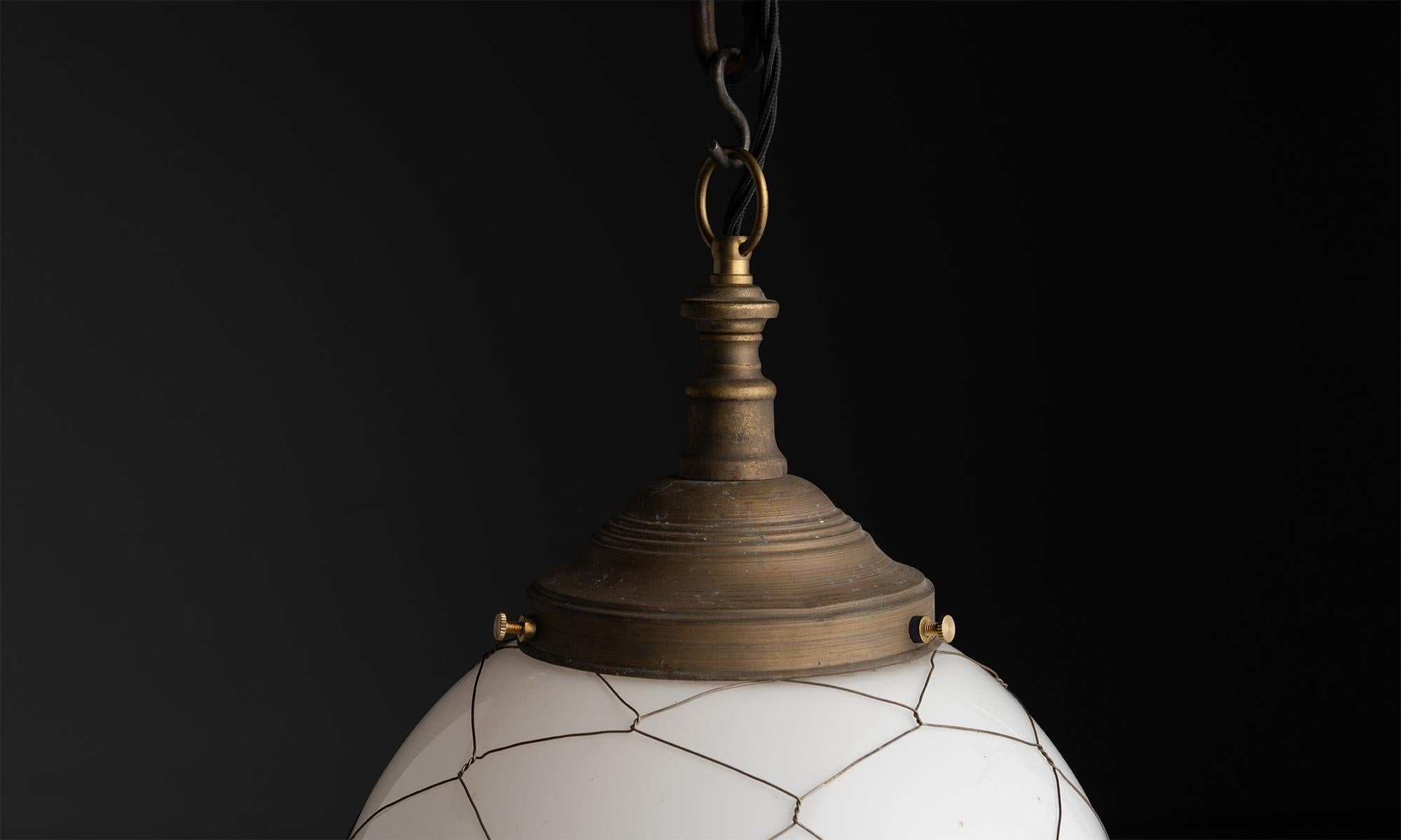 England circa 1920
Wrapped in brass wire caged with opaline milk glass shades.
11
