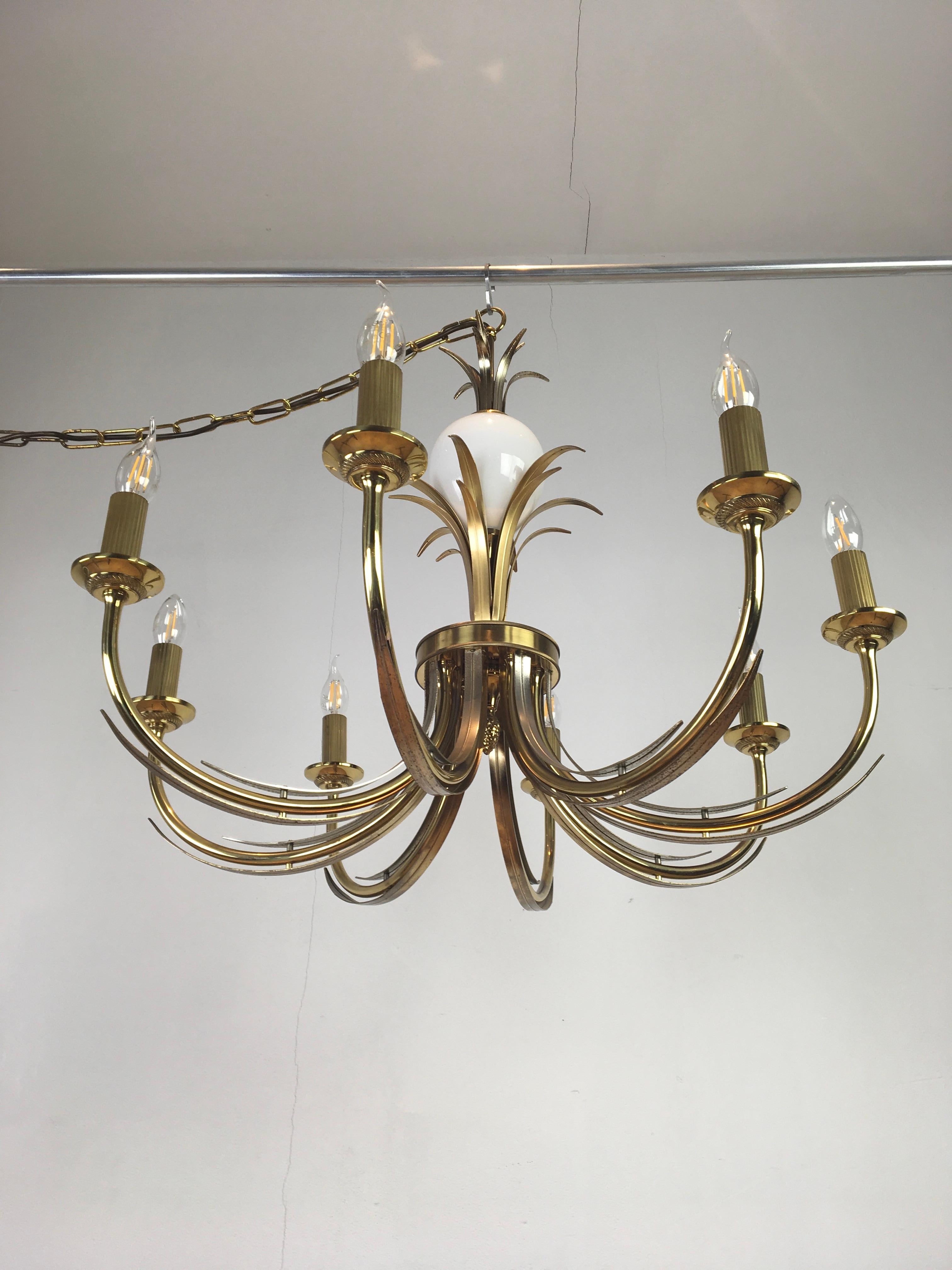 Brass with white opaline glass ostrich egg chandelier by SA Boulanger Belgium. A Hollywood Regency chandelier from the 1970s which is also in the style of Maison Charles.
 
A stylish and elegant ceiling light with 8 arms with gilded metal leaves and