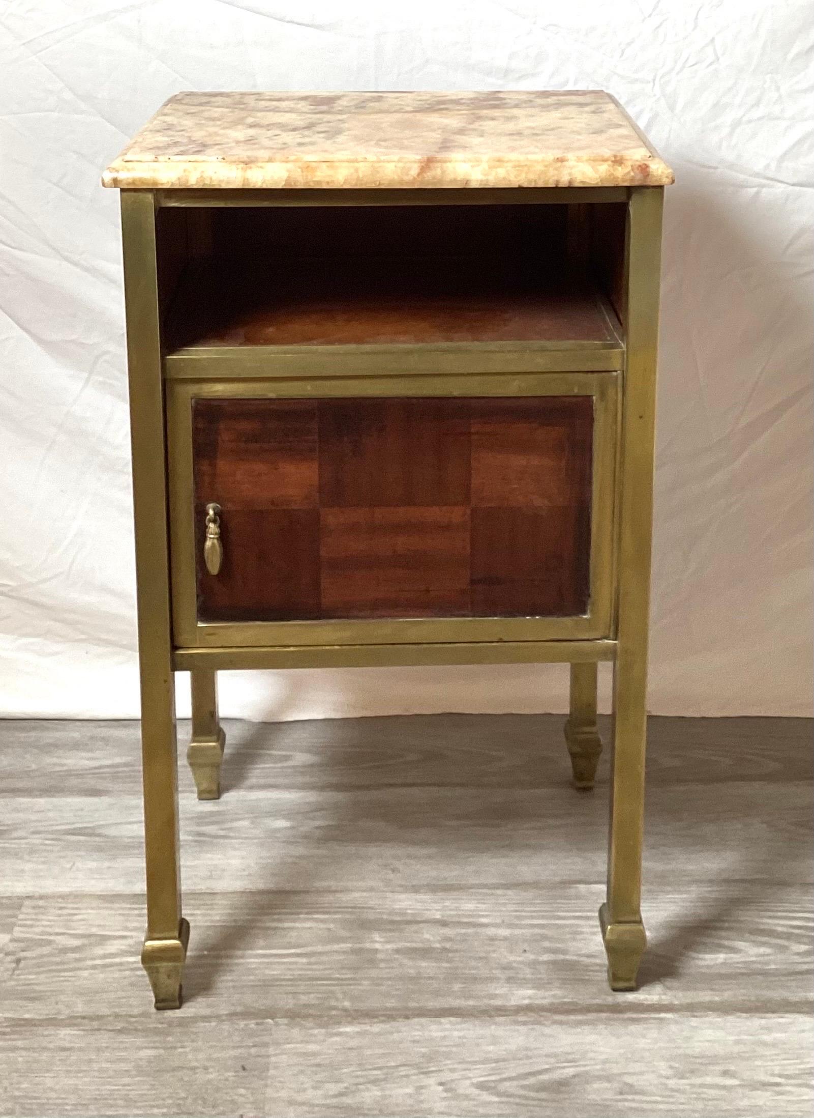 A mahogany and brass night stand or humidor with marble top.  The top open shelf with a lower single door compartment with a marble bottom framed with brass legs and cross bars. 