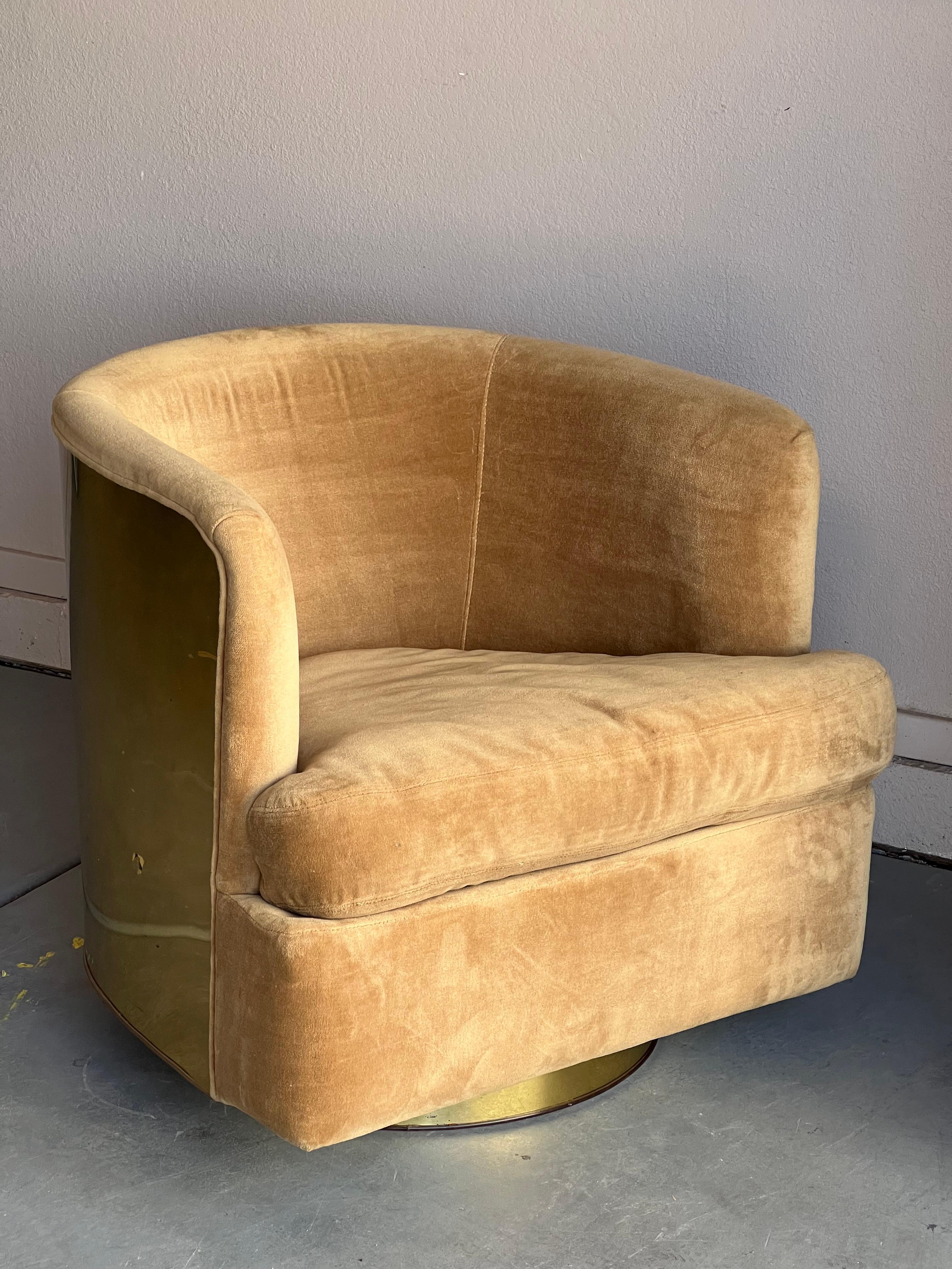 Highly sought-after brass wrapped barrel chair by Milo Baughman for Thayer Coggin. Swiveling and rocking. Original upholstery in nice vintage condition. Brass back shows signs of age and use.

High style with no sacrifice of comfort.  Measures 24