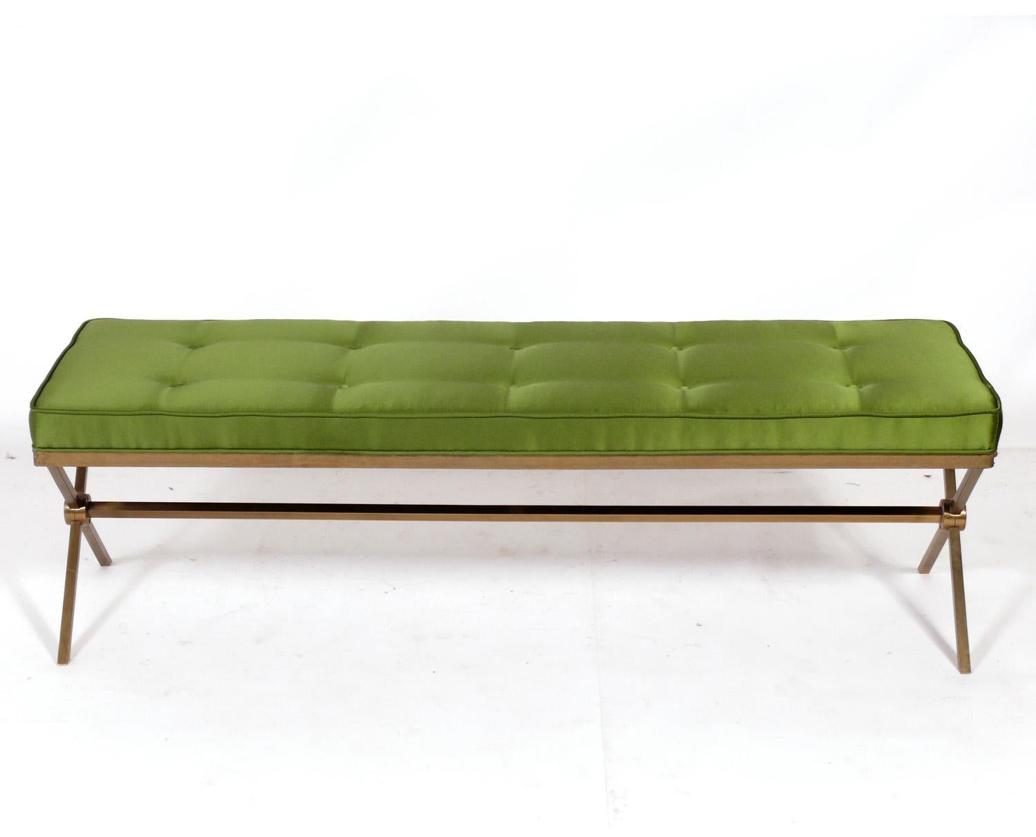 Elegant brass X base bench, American, circa 1960s. Newly reupholstered in a green sateen fabric. Brass base retains warm original patina.