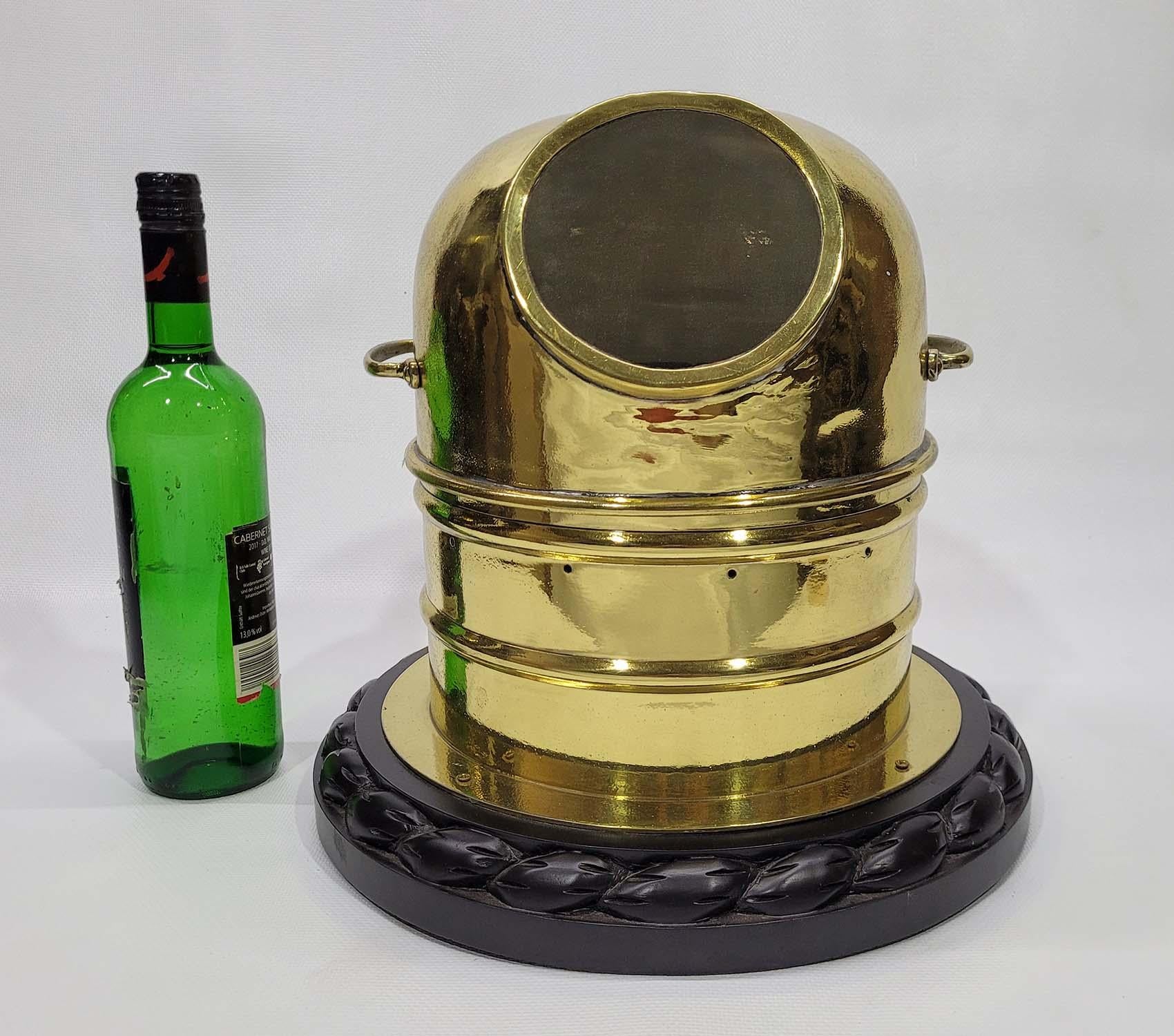 Solid brass boat compass binnacle that has been meticulously polished and lacquered. Gimballed compass inside. Mounted to a varnished wood base with carved rope border. Interior has been fitted with warm led lighting. 

Weight: 5 lbs.
Overall