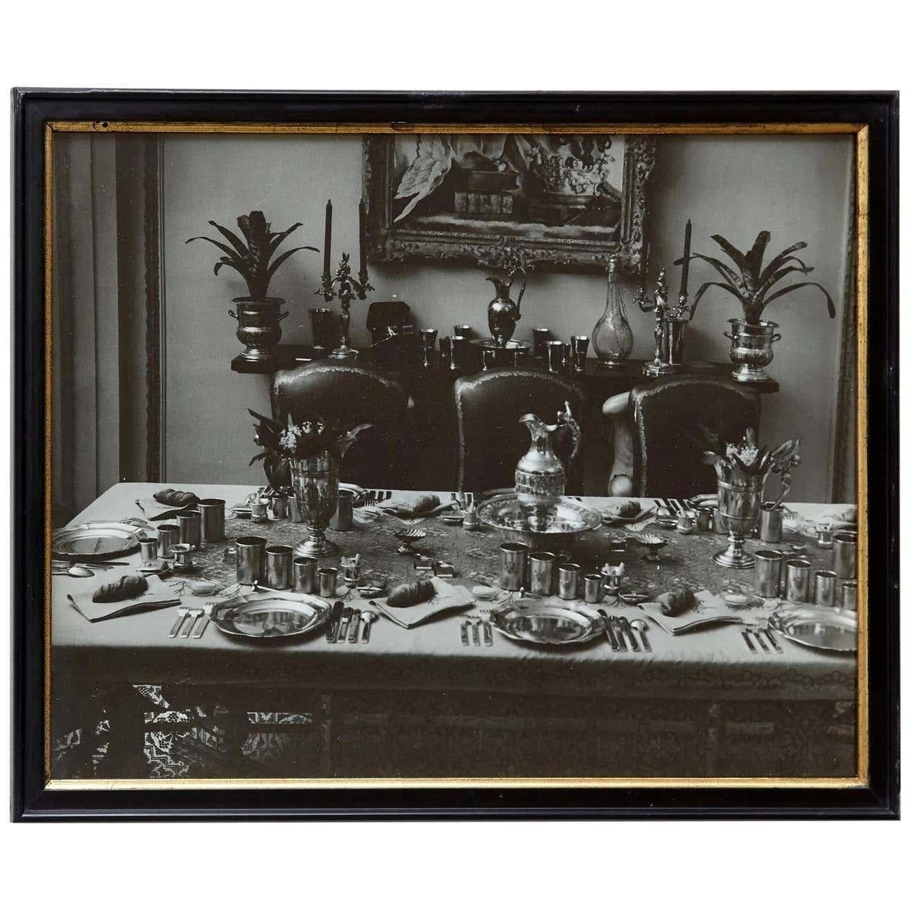 Step back in time with Brassai's captivating lens as he beautifully frames a dinner table in 1935 Paris. This black and white gelatin silver bromide photograph, stamped by the master himself, captures the essence of a bygone era, inviting you to