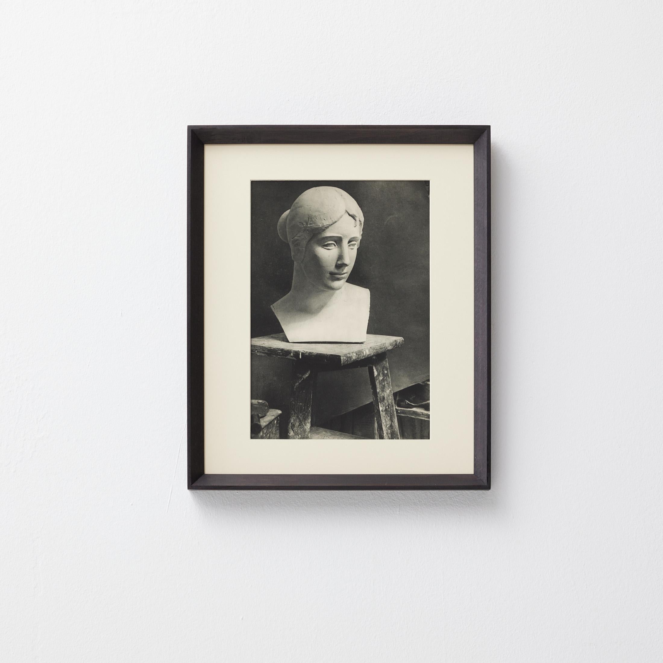 Original heliogravure by Brassaï (1899–1984) published in the prestigious first issue of Verve, the avant-garde art magazine founded by Tériade. This particular image captures a serene plaster bust resting atop a rustic wooden stand in what appears