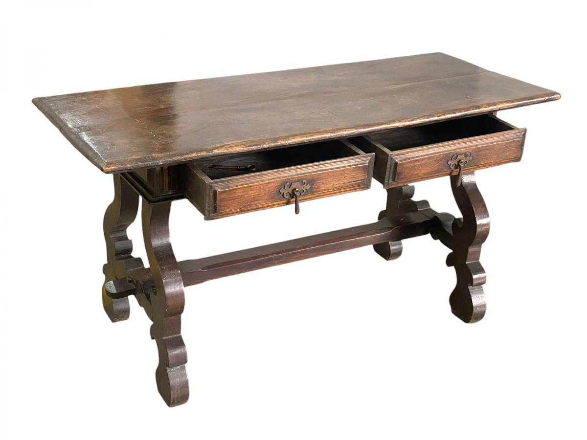 This elegant sideboard or console table, crafted in the 1940s during the Brazilian Colonial Revival period, exudes the charm and craftsmanship characteristic of this era. The table features a robust, dark wood construction with a richly patinated