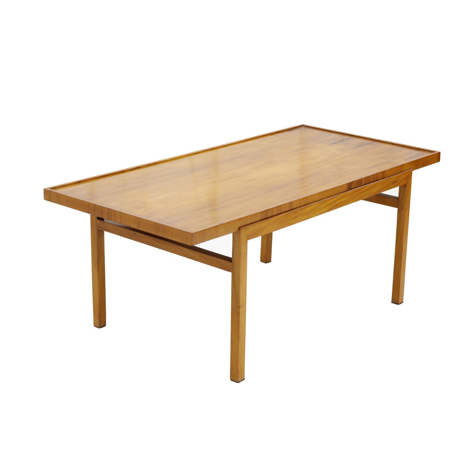 Brazilian midcentury coffee table in caviúna wood by Peter Kraft, 1950s.

Peter Kraft opened his own store in Sao Paulo in the 1950s. He designed clear shapes and usually worked with Caviuna wood with great attention to detail.