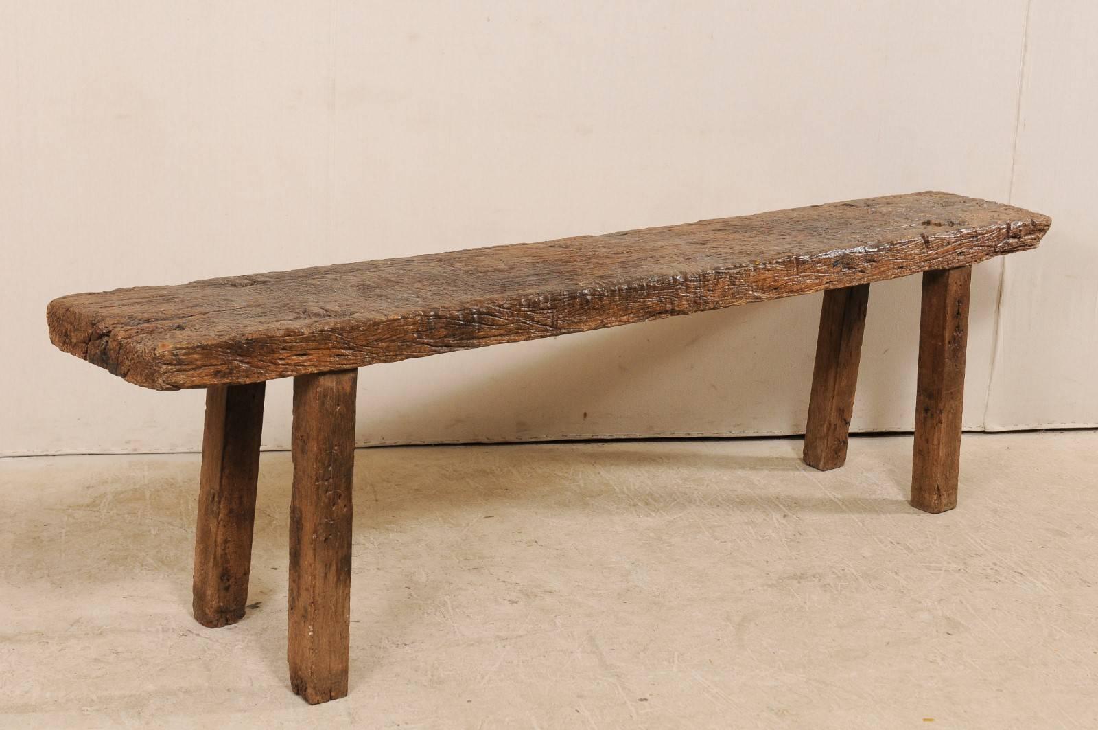 A Brazilian 19th century wooden bench that would function perfectly as a sofa or window table. This antique piece has a long, slender, rectangular shape and is over 8 feet in length. It is made from peroba wood, a tropical native hardwood to Brazil