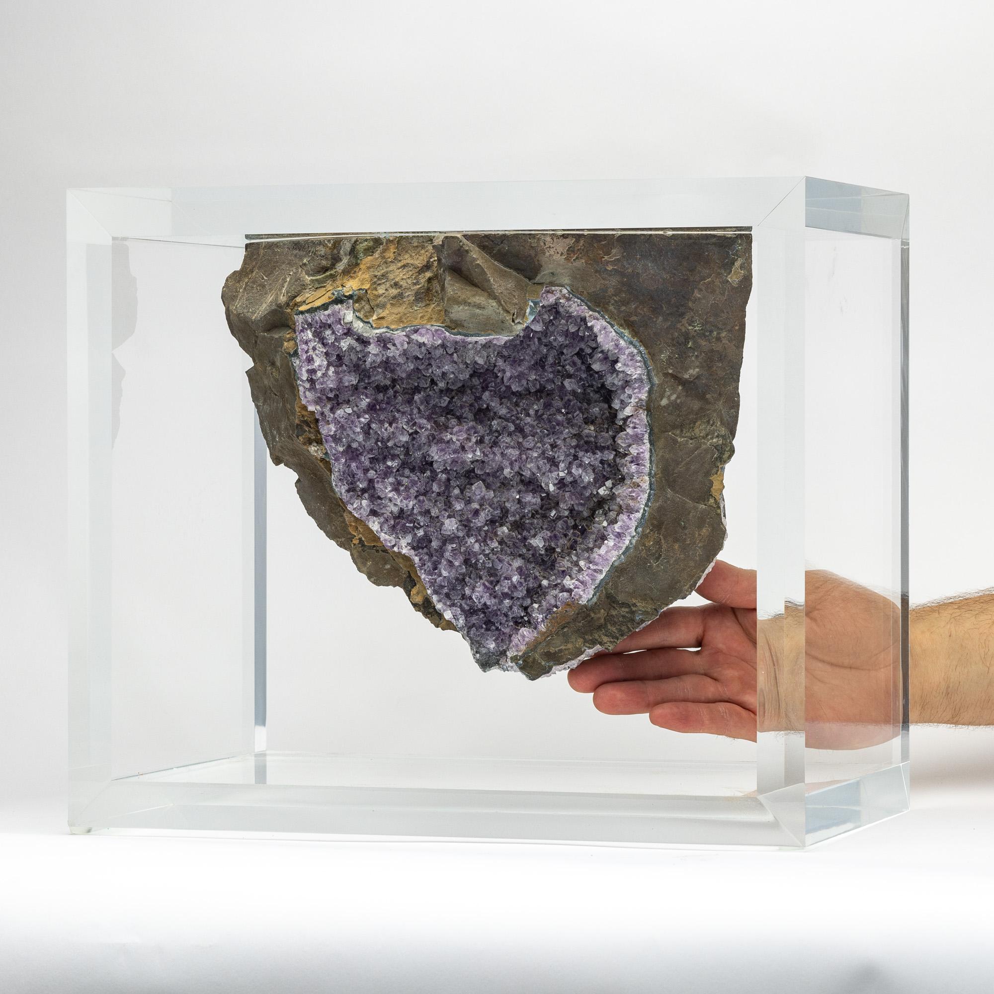 A unique specimen of free form Amethyst geode with basalt from Brazil. With impressive large purple crystal spikes, covered with smaller spikes and white quartz crystallizations.  Mounted in an original designer acrylic case. 

