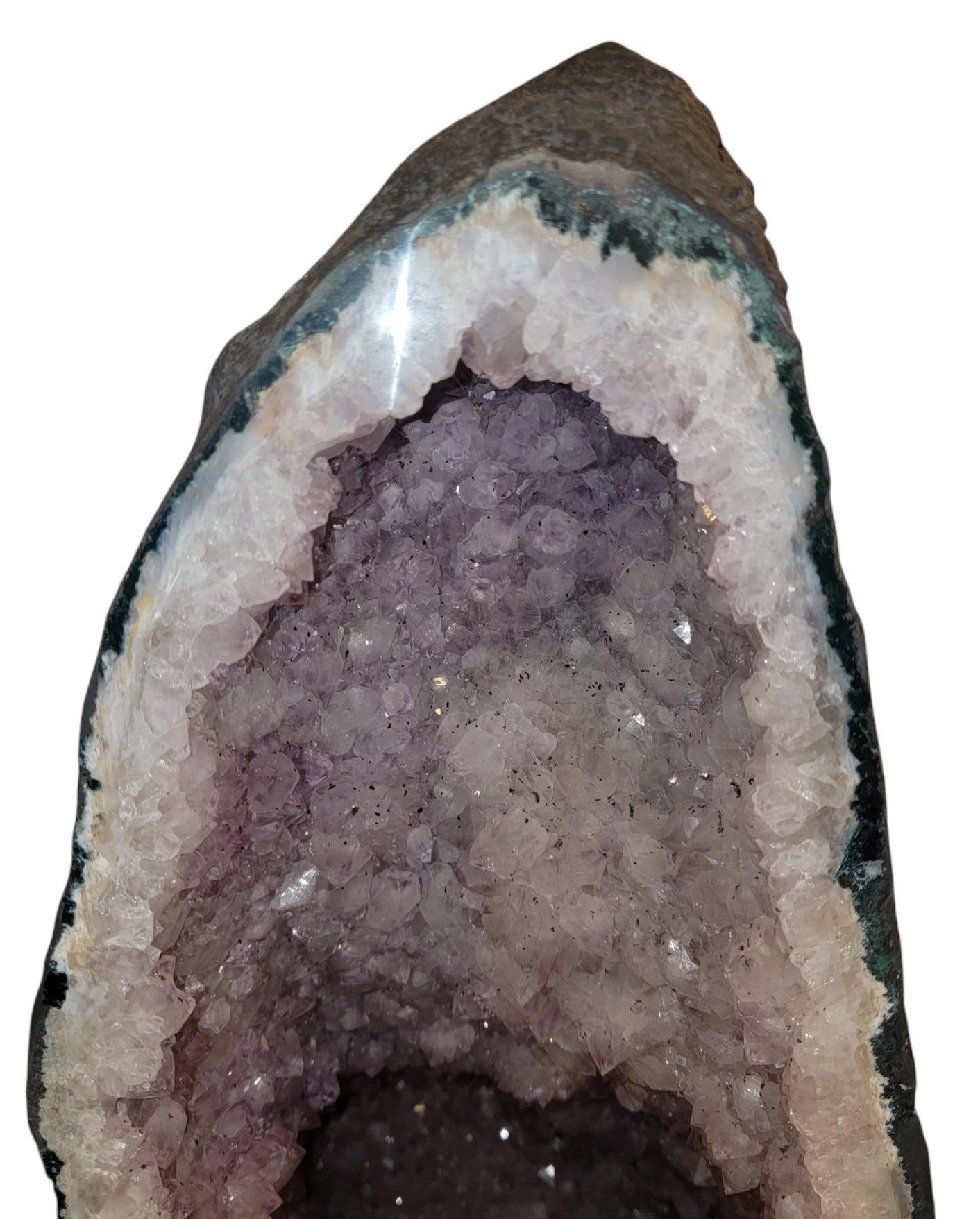 Brazilian Amethyst Quartz Cathedral Geode. This item is a standalone item. The Geode needs no support. This item has beautiful amethyst crystals within the crusted frame.


9.5 x 10.5 x 27.