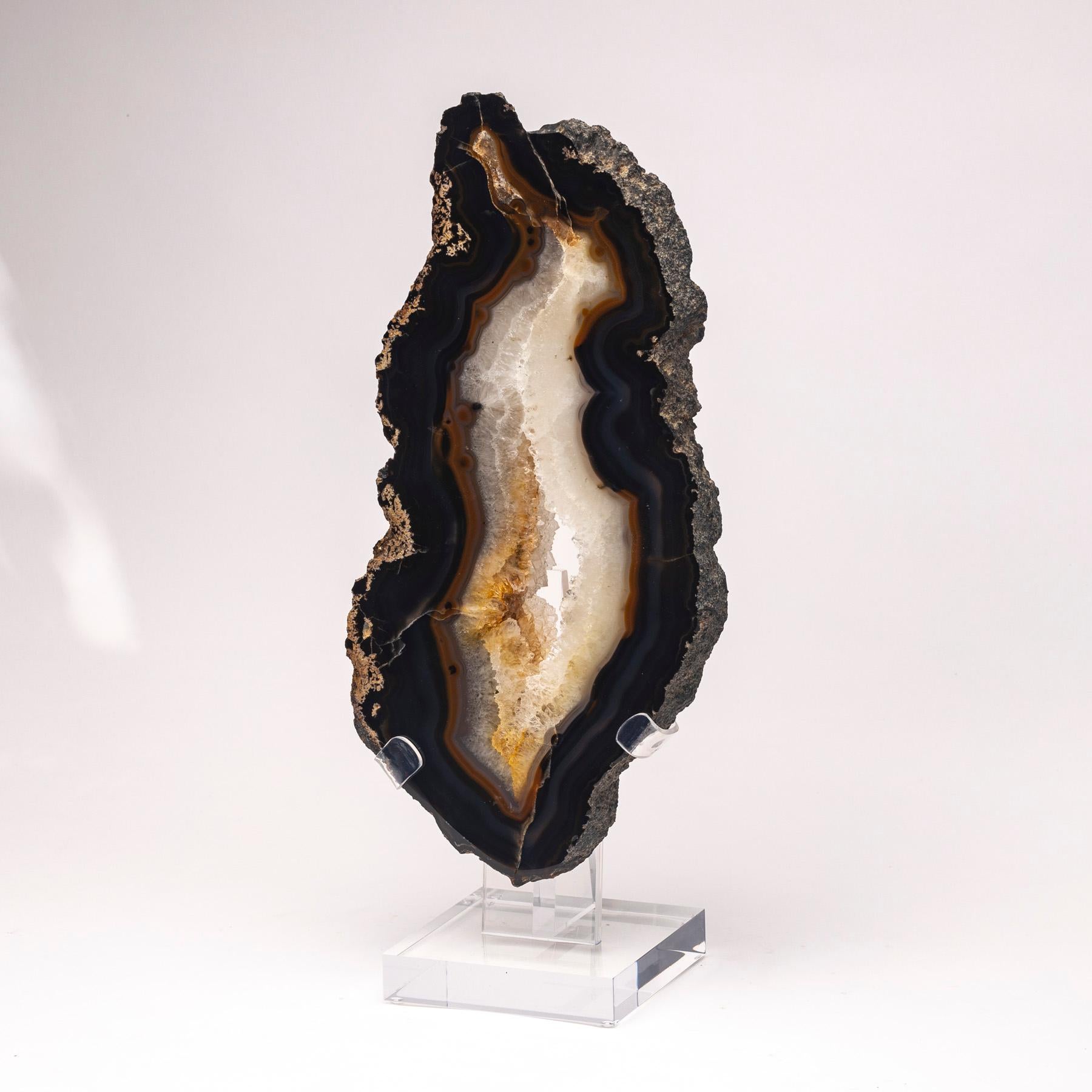 Top grade agate slab from Brazil.
Agates are formed in rounded nodules, which are sliced open to bring out the internal pattern hidden in the stone. Their formation is commonly from depositions of layers of silica filling voids in volcanic vesicles