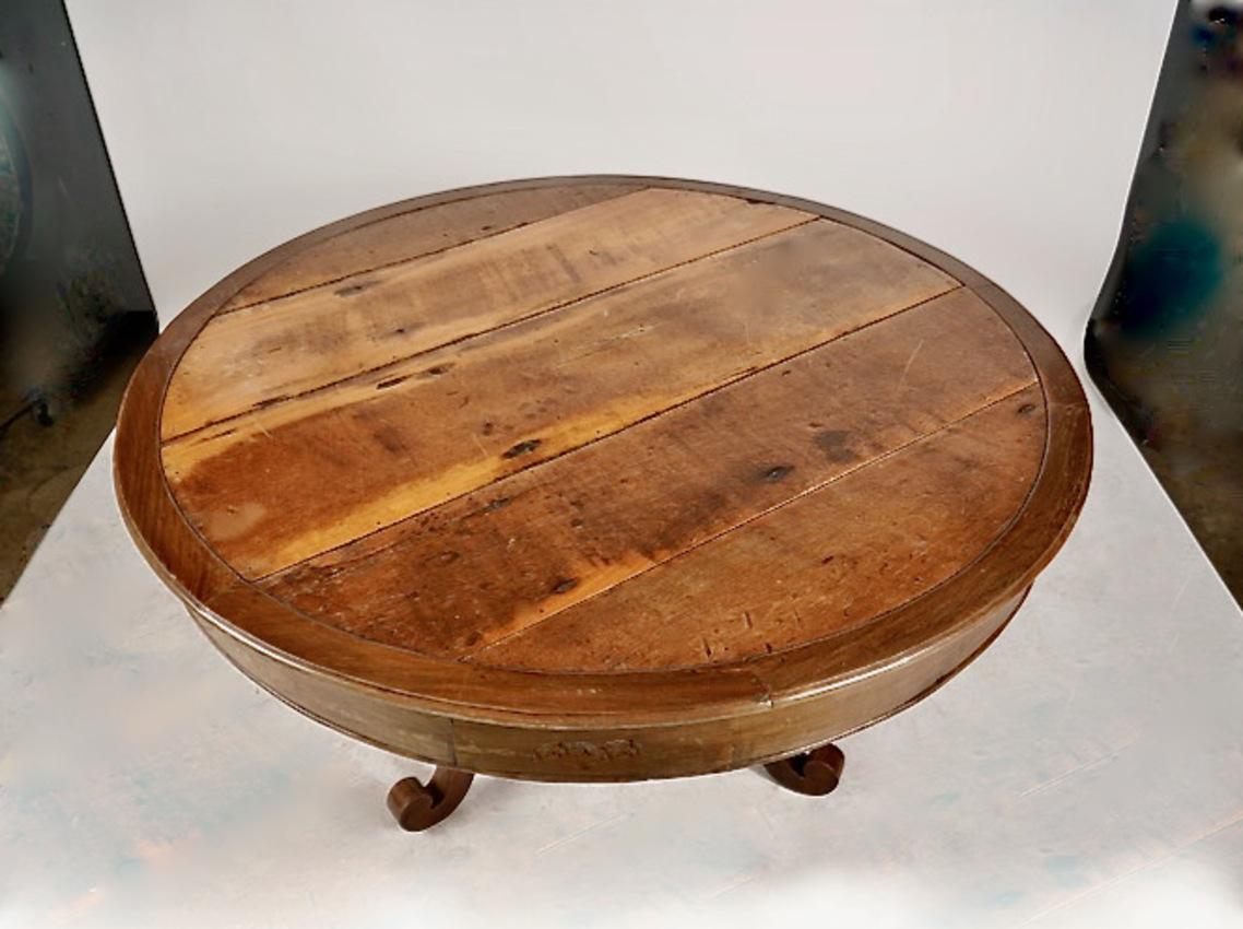 This is a unique Rustic Brazilian Walnut and Peroba wood table that was created in the mid-19th century in the Colonial Brazilian style. The large 56