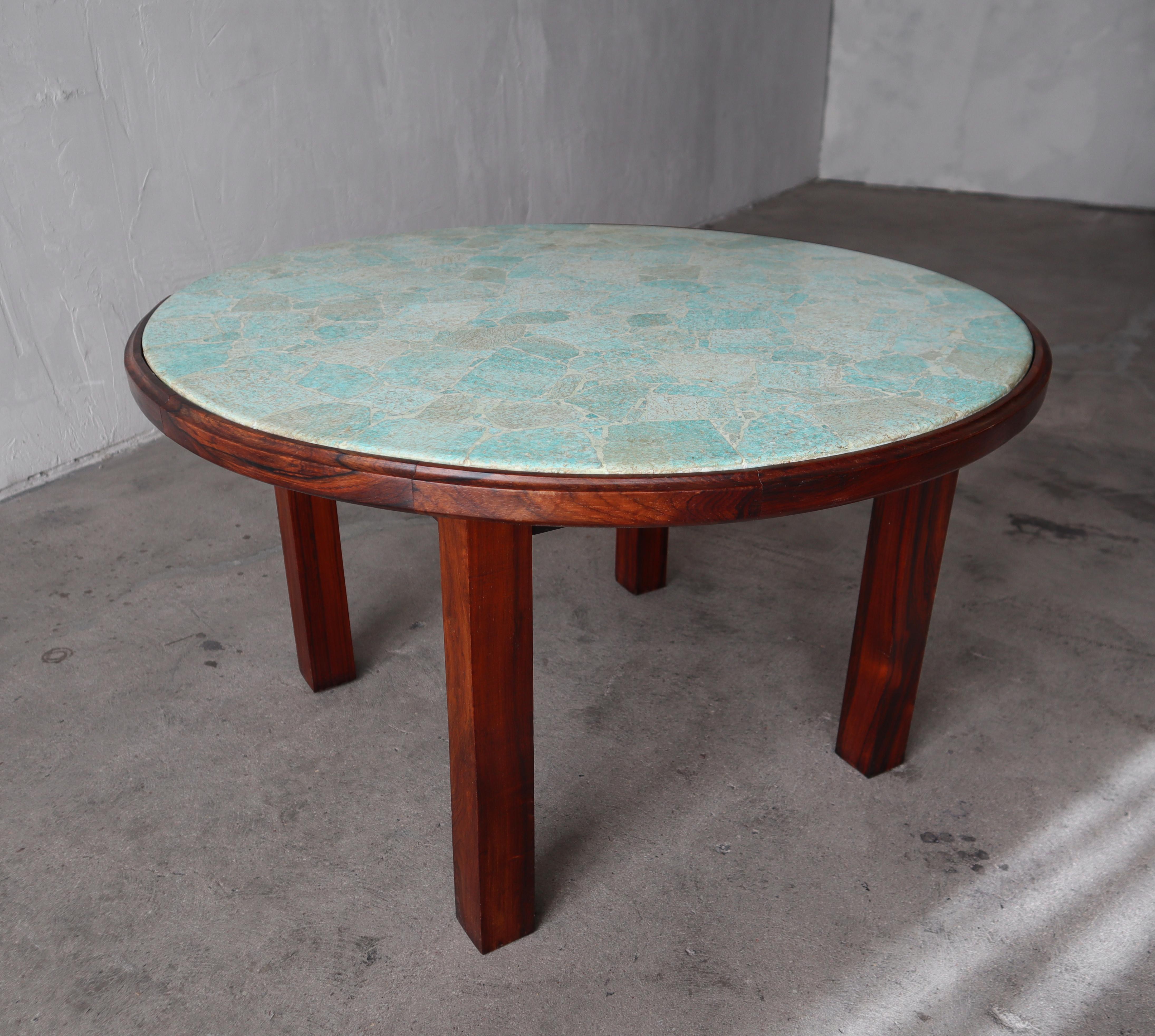 We purchased this incredible table from the original owner who had it custom made in Rio de Janeiro, Brazil in the 1960s. The table is constructed out of solid Brazilian rosewood and beautifully, hand placed jade stones. He told us that the top was