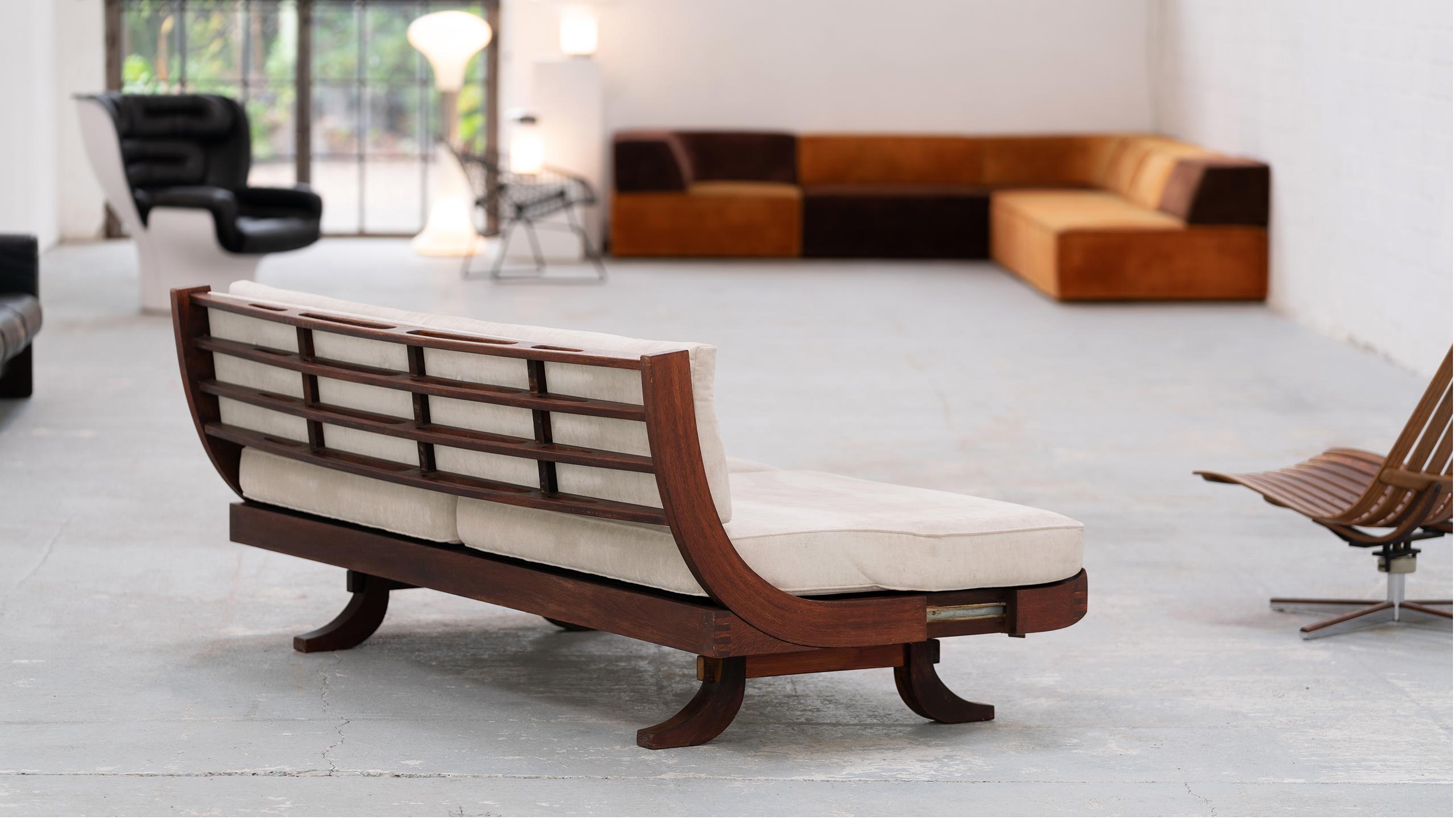 Here you have the opportunity to purchase a convertible daybed with incredibly sophisticated wood details on the backrest. 

Get an impression from the photos, the backrest can be pulled back to give the seat more depth, so the sofa becomes a
