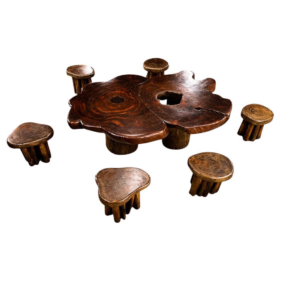 Brazilian “Denúncia” Sculptural Table 
Six Matching Stools in Reclaimed Wood