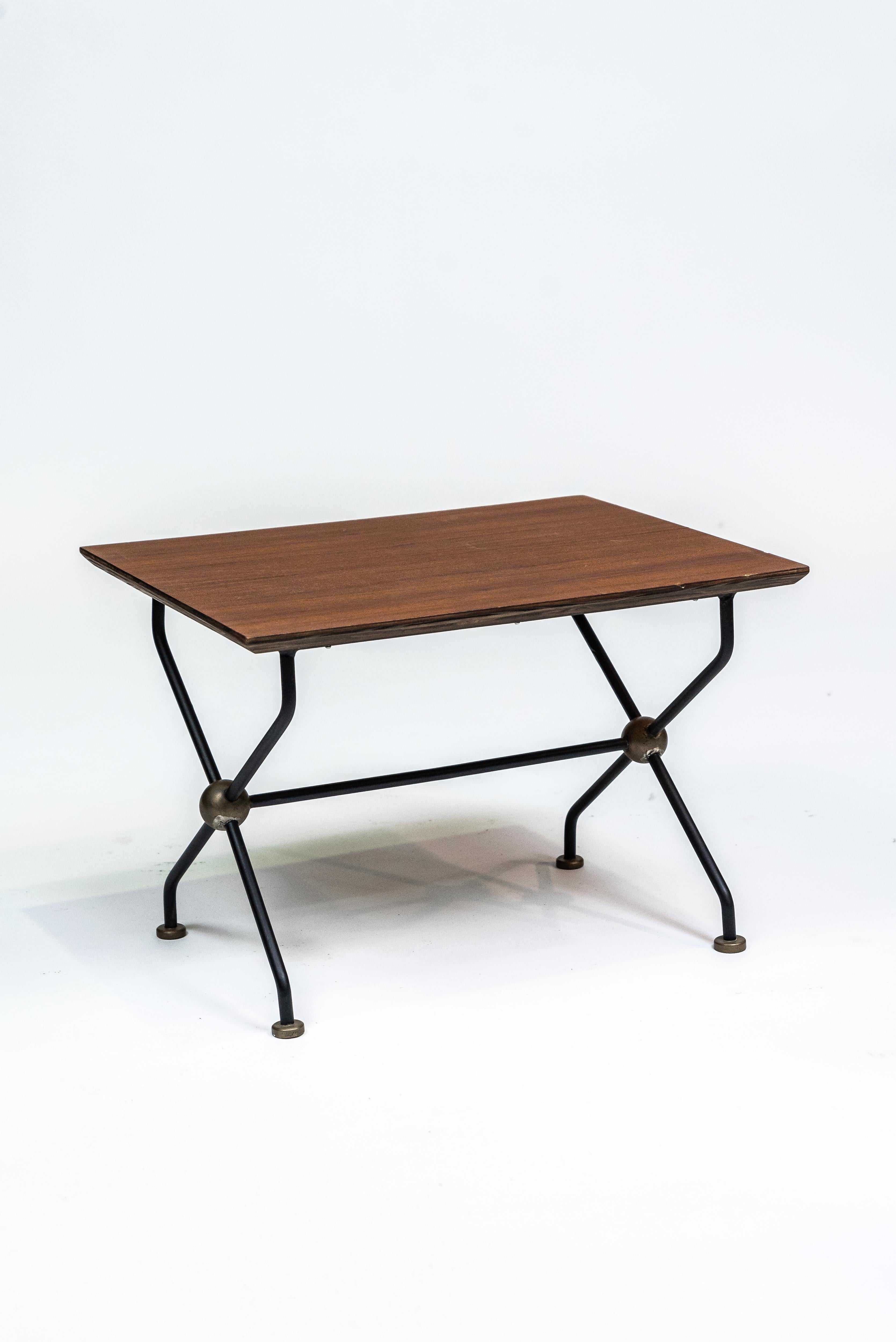 Brazilian Design  
Side Table, c. 1955  
Teak, brass, and iron  
Dimensions: 40 x 57 x 43 cm (15 3/4 x 22 11/25 x 16 93/100 in)

This beautiful side table exemplifies mid-century Brazilian design. Crafted from teak, it features a striking