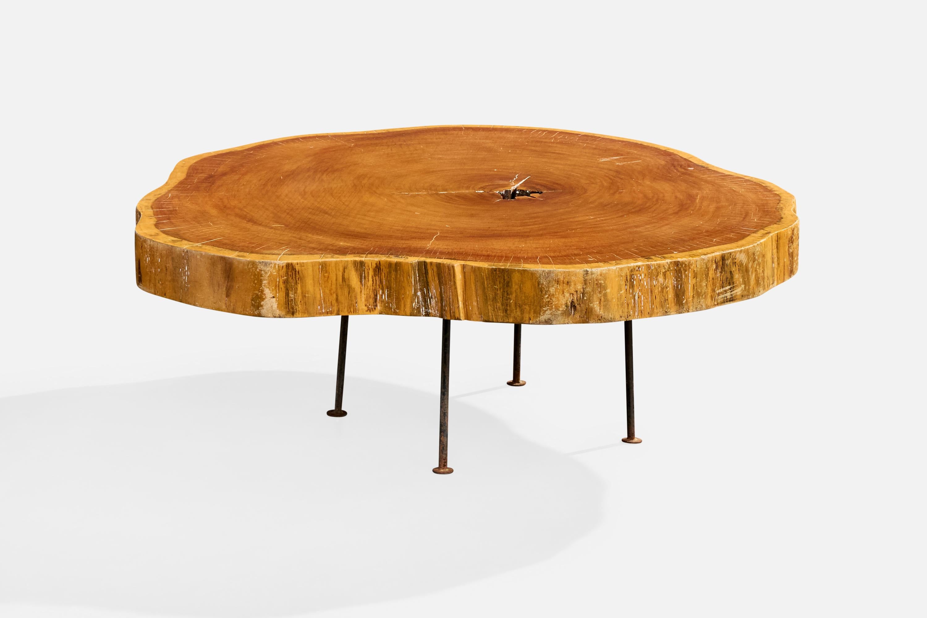 A solid wood and iron coffee table designed and produced in Brazil, c. 1960s.

Heavy oxidation present throughout iron base.

Overall Dimensions (inches): 15.0
