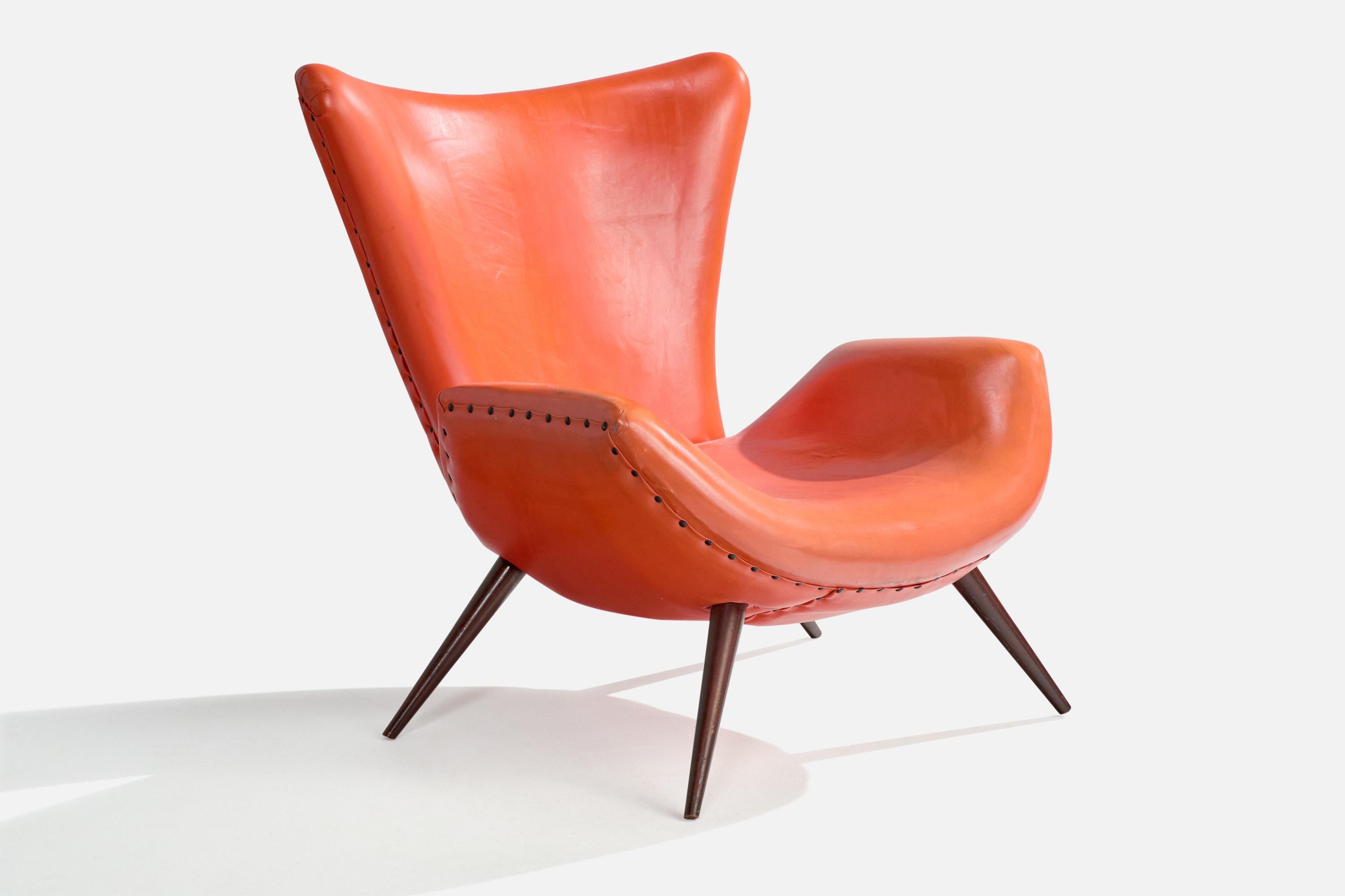 A dark-stained wood and red leatherette lounge chair designed and produced in Brazil, c. 1950s.

Light scratching to wooden legs. Light staining, a couple small tears, and general wear to leather.

Overall Dimensions (inches): 33.5” H x 31” W x 36”