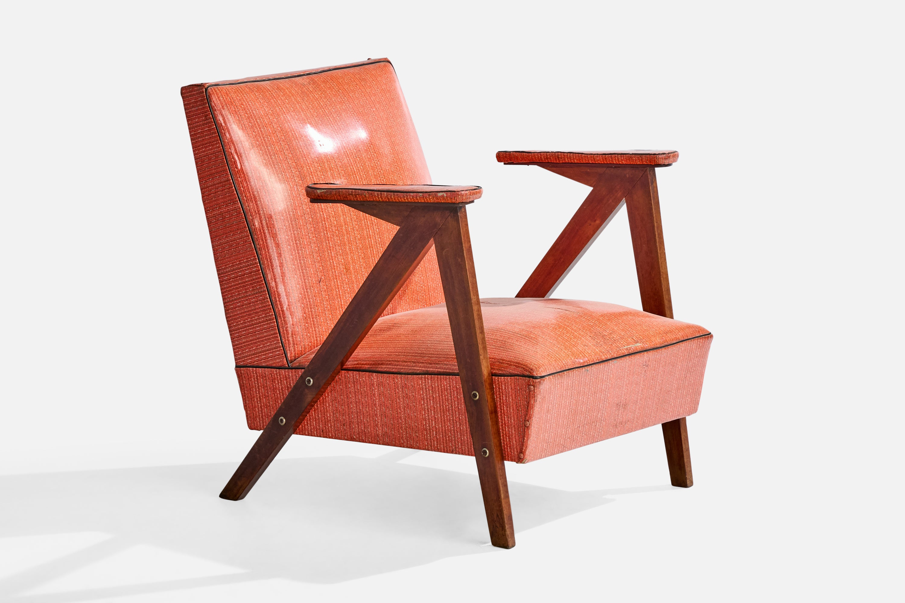 A wood and red vinyl lounge chair designed and produced in Brazil, c. 1950s.

Vintage fabric in distressed condition

Wear consistent with age and use

Overall Dimensions (inches): 28.25