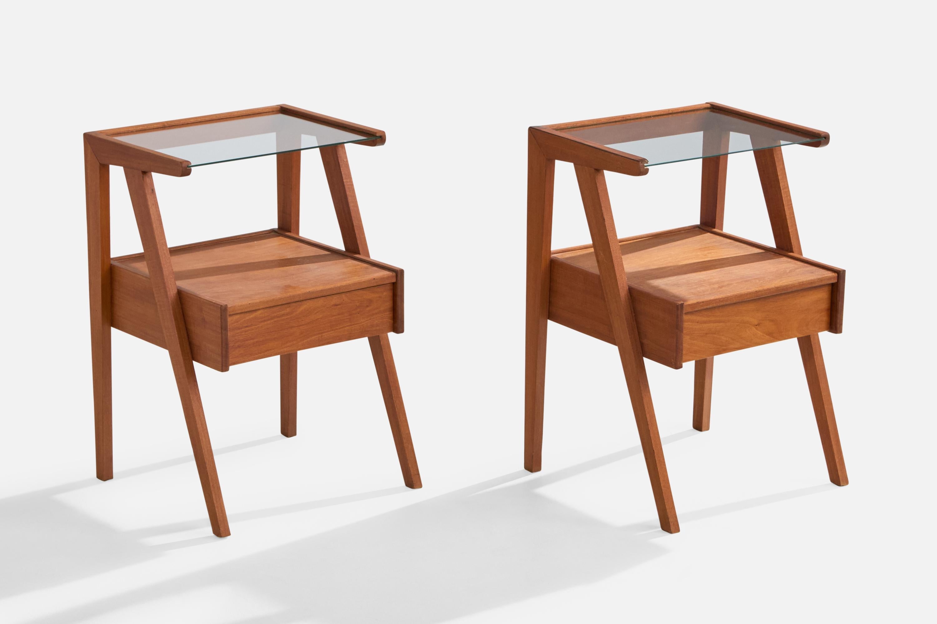 A pair of wood and glass nightstands designed and produced in Brazil, c. 1950s.

Dimensions: 24” H x 16.15” W x 15” D