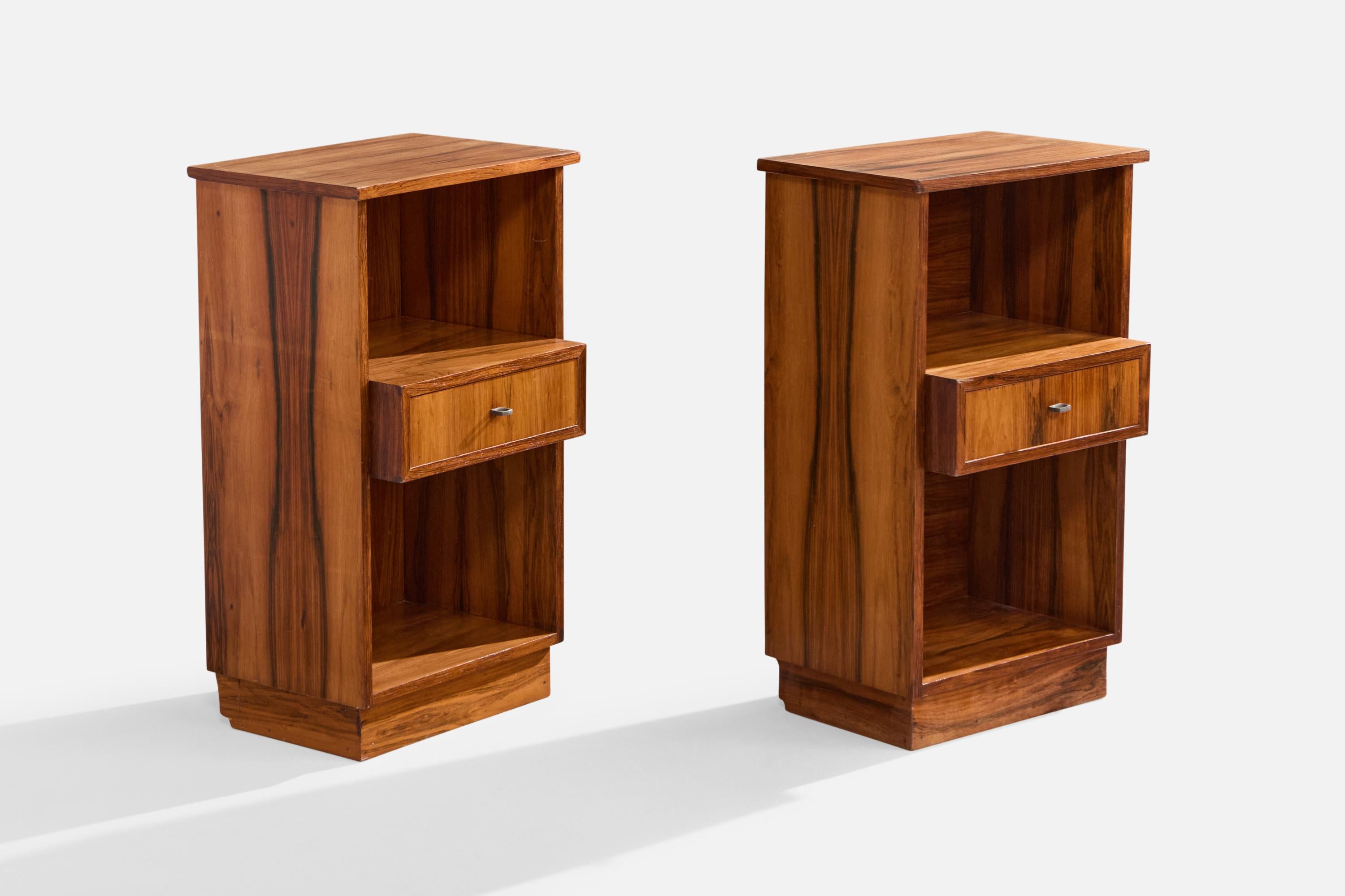A pair of wood and metal nightstands designed and produced in Brazil, c. 1950s.

Very light scratching and discoloration to top surfaces.

Dimensions: 31.5” H x 18.2” W x 14.2” D