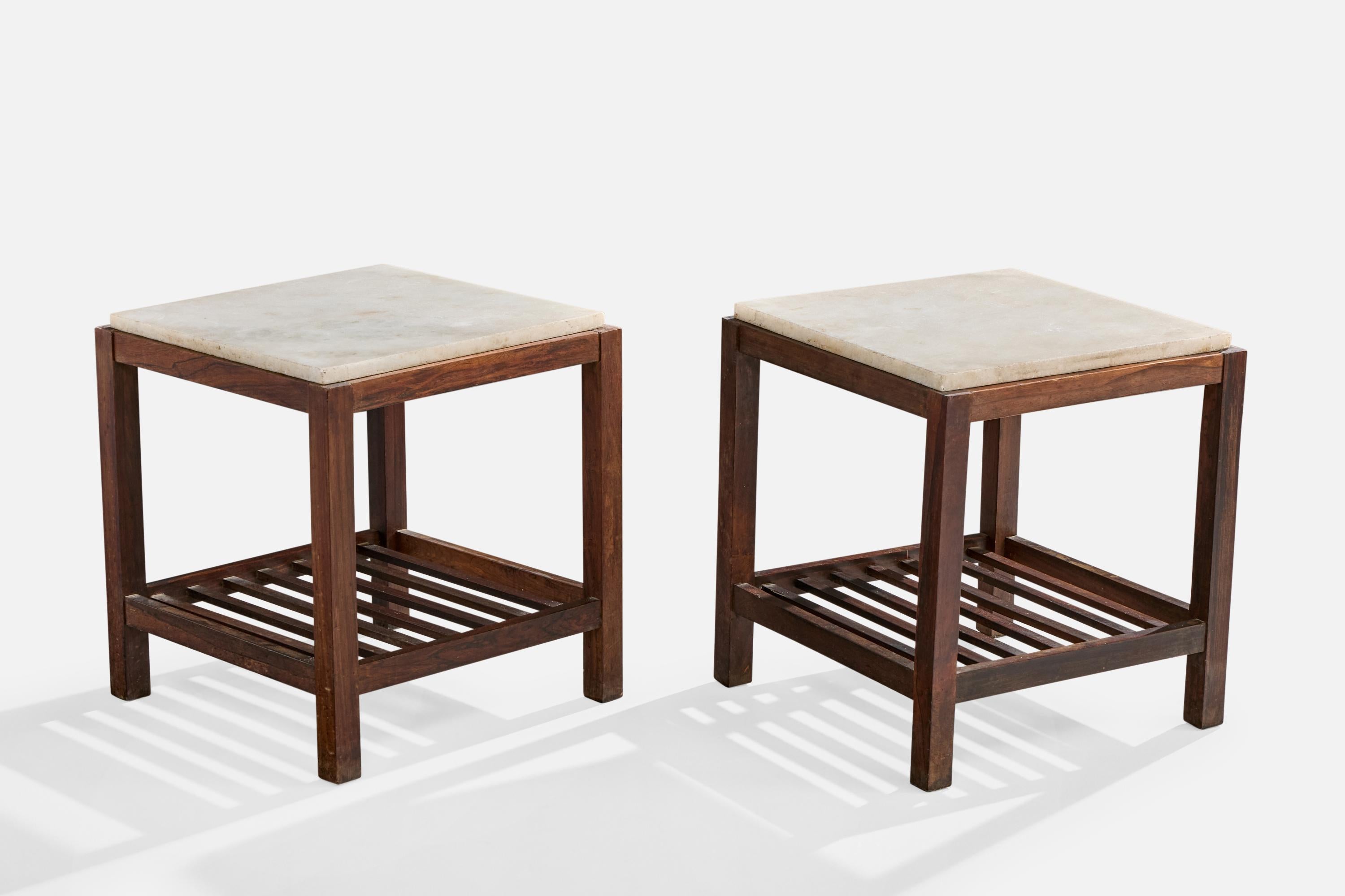 A pair of dark-stained wood and marble side tables designed and produced in Brazil, c. 1950s.

Very light discoloration present throughout wooden structure; very light scratching and staining on one marble top; one small, faded cup stain on each