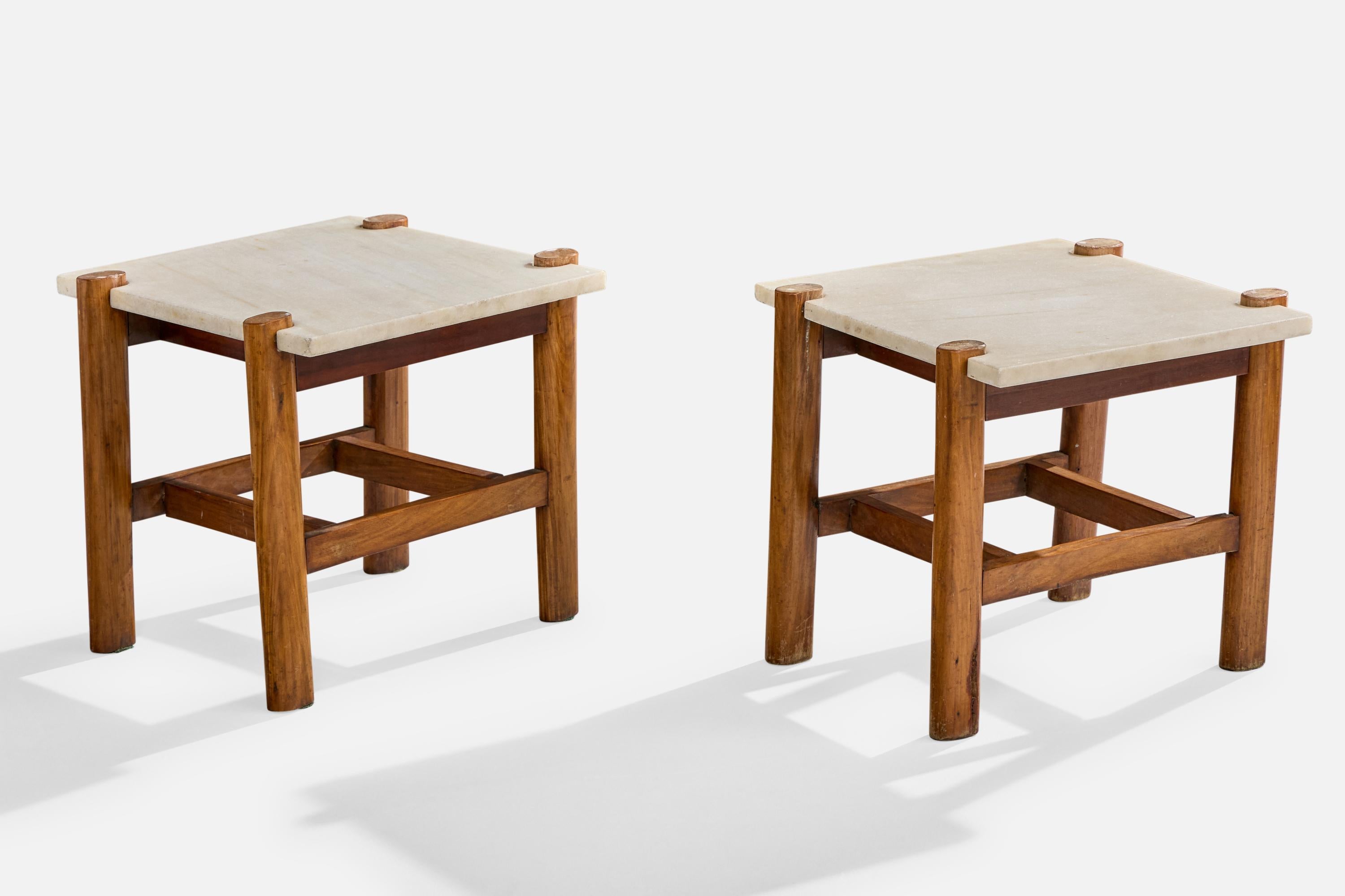 A pair of marble and wood side tables designed and produced in Brazil, c. 1960s.

Light discoloration to wood.

Split to veneering near bottom of one of the legs as illustrated.

Dimensions: 16.6” H x 22.75” W x 21.325” D