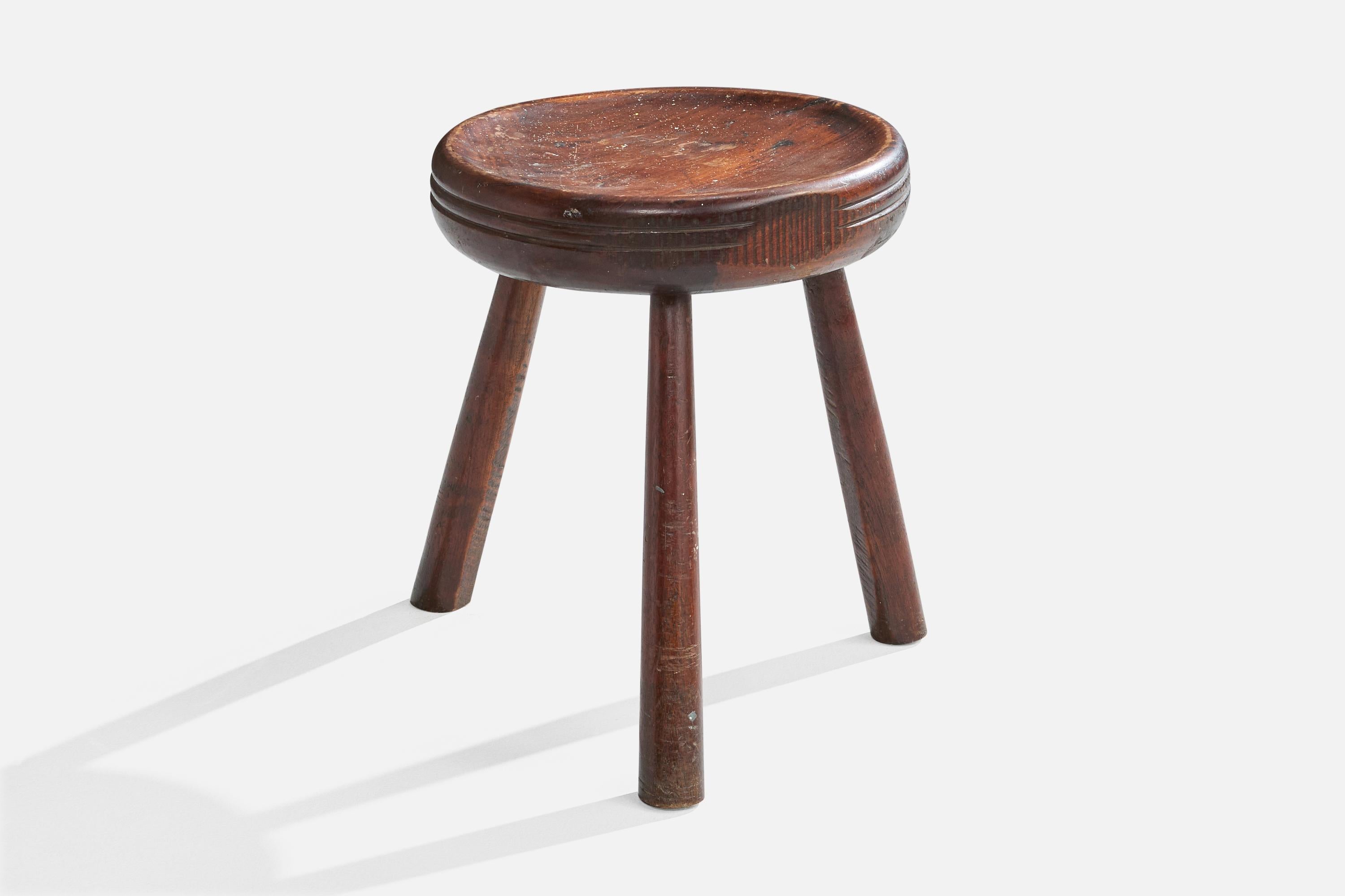 A dark-stained wood stool designed and produced in Brazil, c. 1950s.

Light staining and scratching throughout.

Dimensions: 16.5” H x 13.375” Diameter