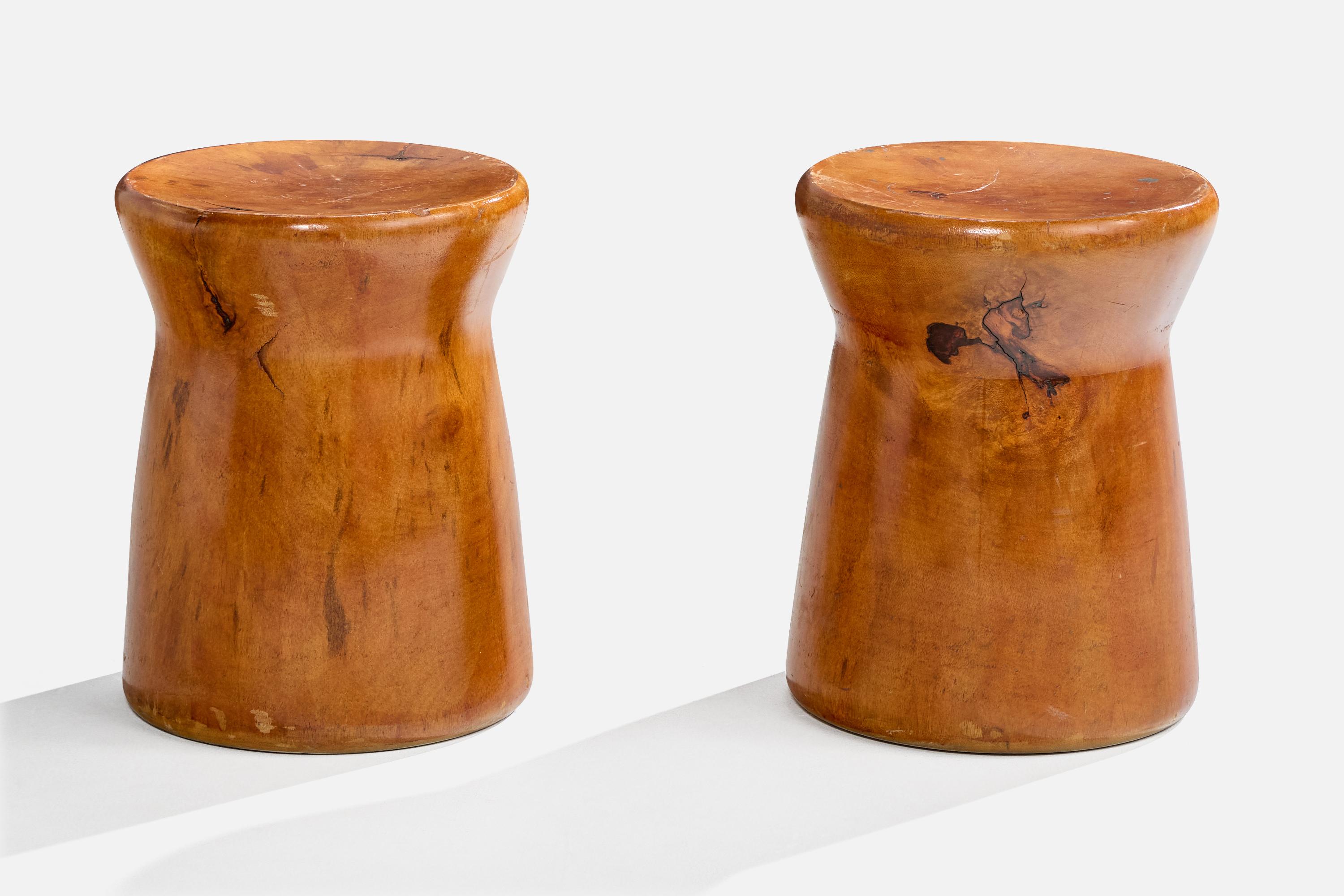 A pair of solid wood stools designed and produced in Brazil, c. 1980s-1990s.

Light scratching throughout stools.

Dimensions: 17.75” H x 13.5” Diameter
