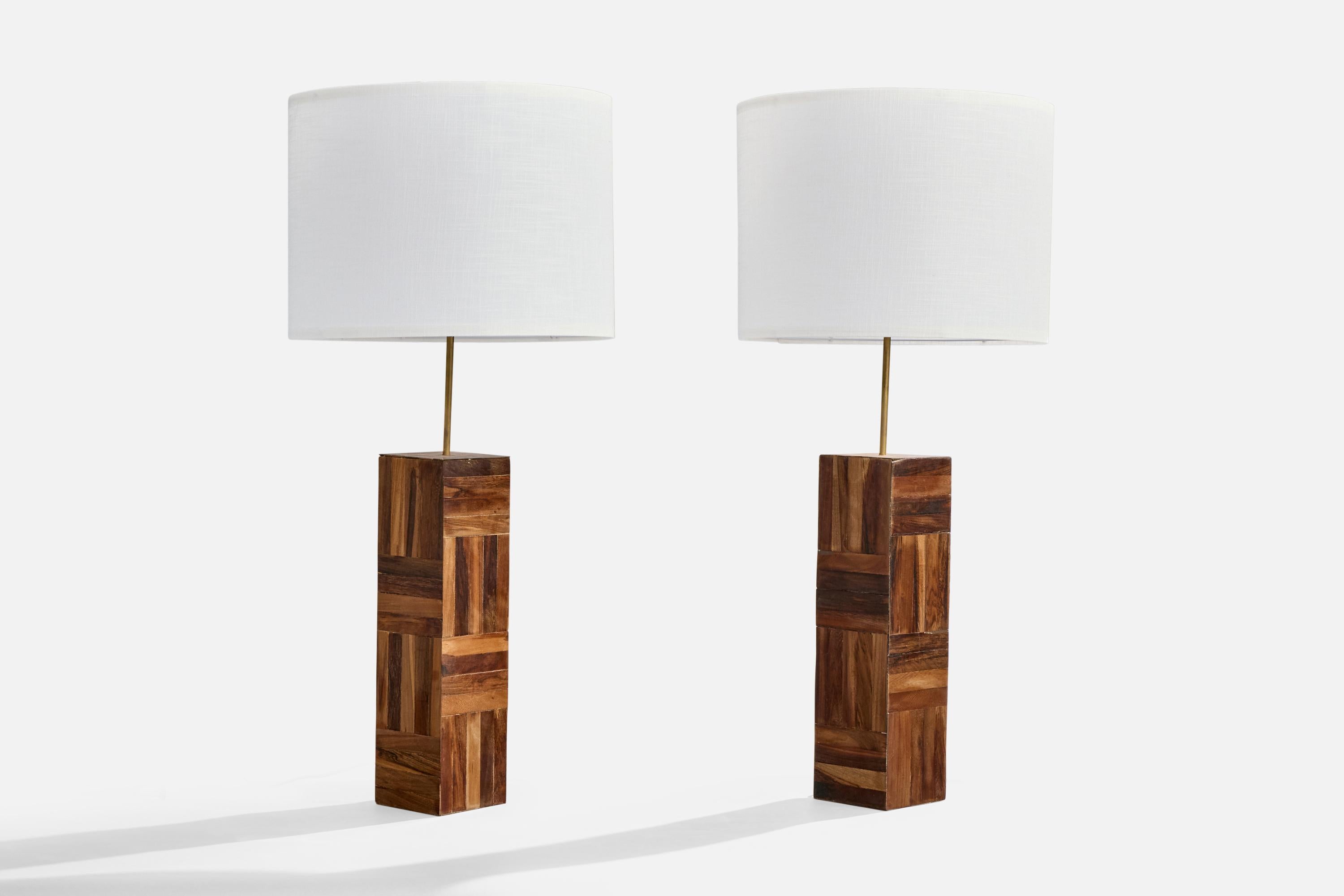 A pair of sizable wood and brass table lamps designed and produced in Brazil, c. 1950s.

In all-original condition, dramatic wear to wood veneer as illustrated, light oxidation to brass neck.

Dimensions of Lamp (inches): 30“ H x 4.75” W x 4.75”