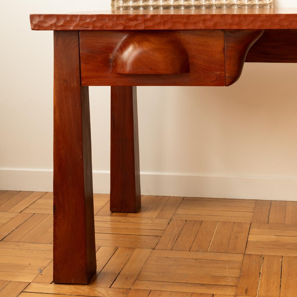 Brazilian work,

Solid mahogany desk with a rectangular top, partially gouged, and resting on four quadrangular uprights.
It opens on the front with two drawers with carved handles.