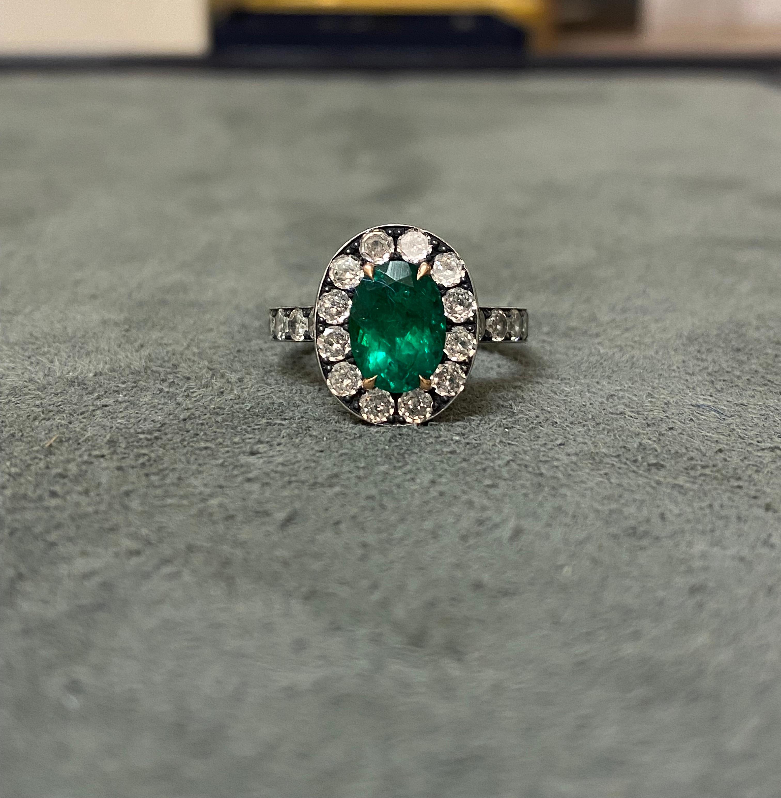 A Brazilian emerald set with diamonds in 18k rose gold and blackened silver. The emerald weighs 1.79ct, with minor oil treatment. The stone is certified by SSEF, and a copy of the certificate is available if interested. 33 diamonds (total weight